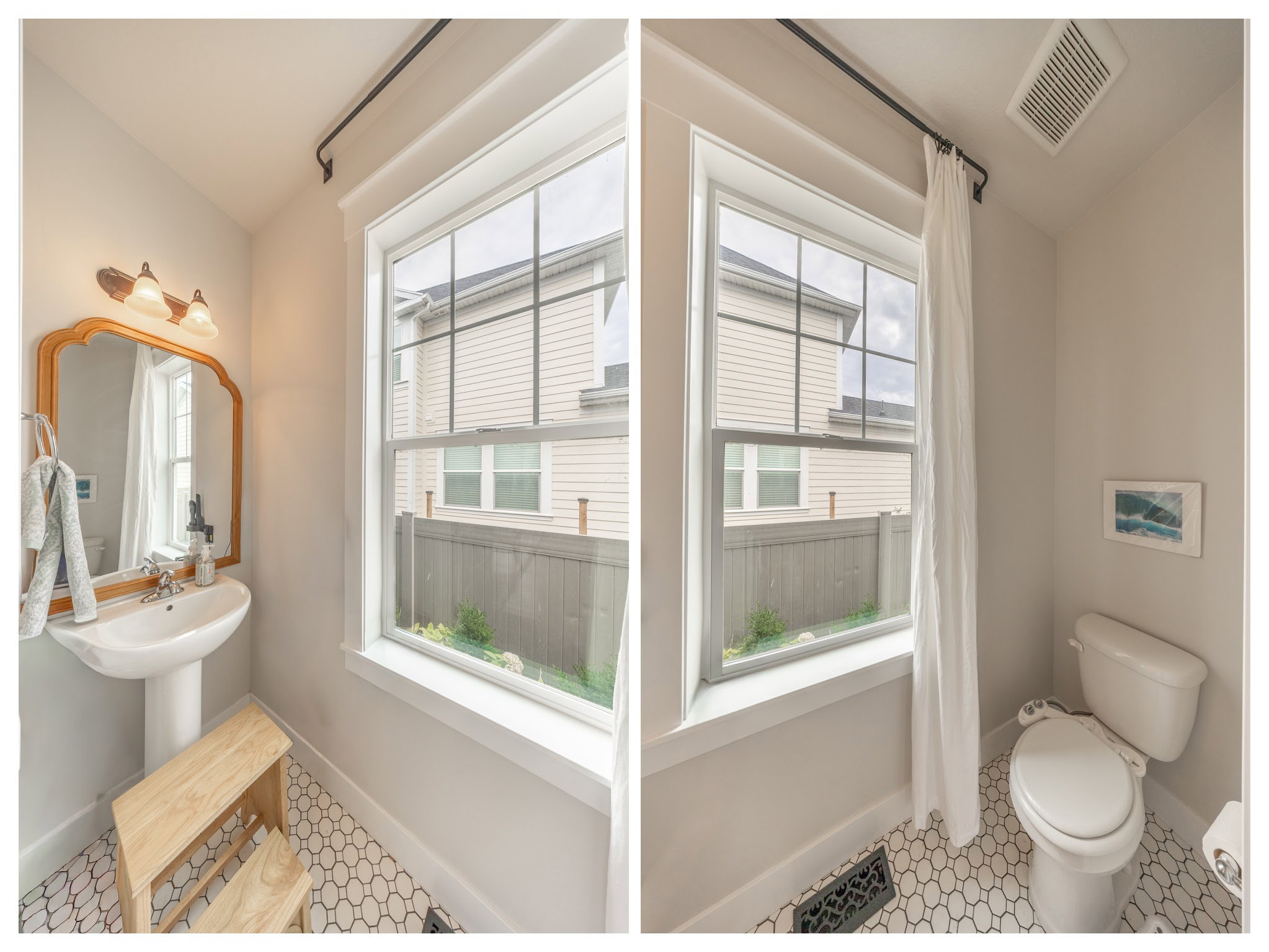Bright bathroom featuring a pedestal sink, a wood-framed mirror, and a two-light vanity fixture