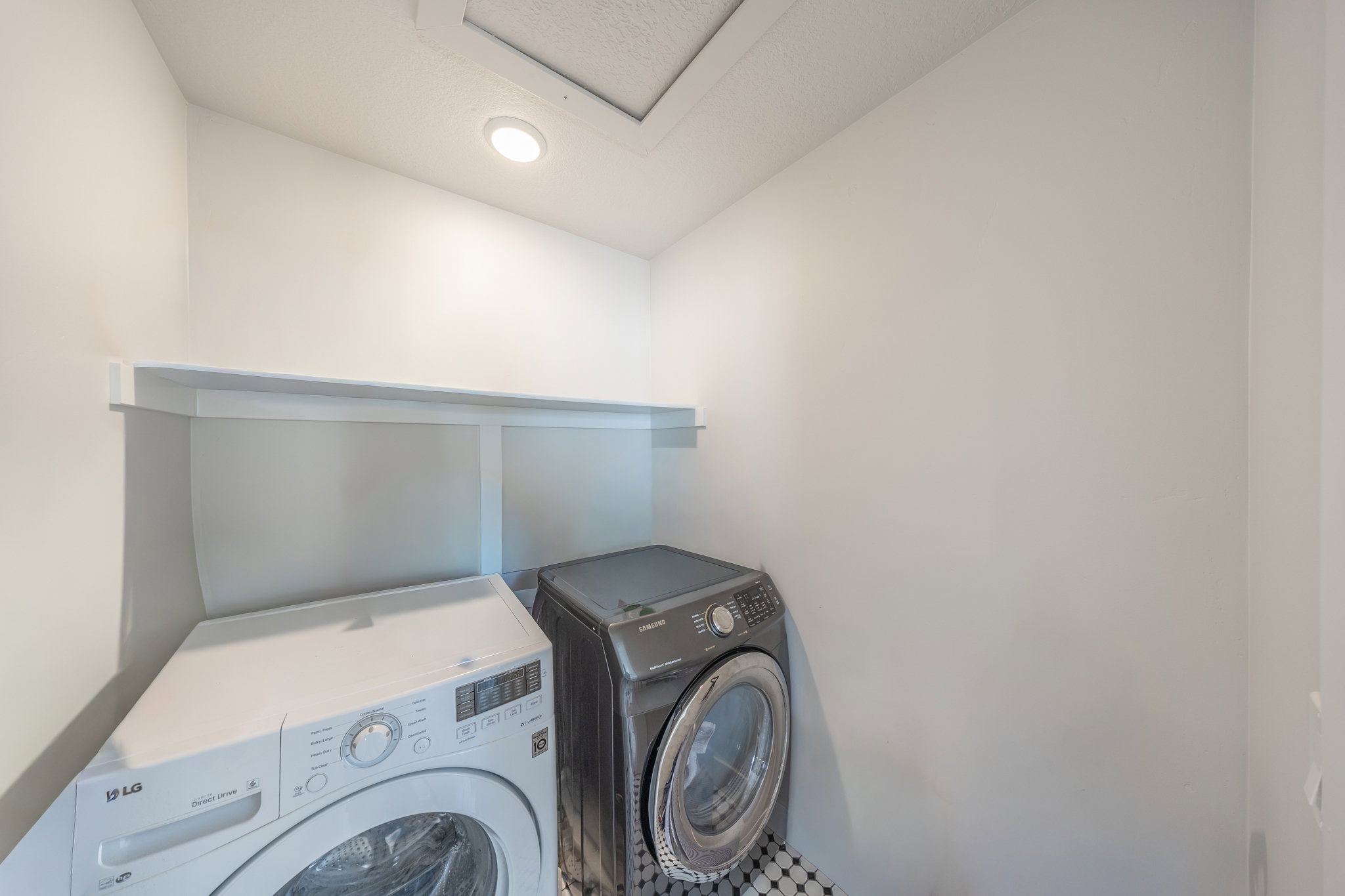 Dedicated laundry area featuring a built-in white shelf and recessed ceiling lighting
