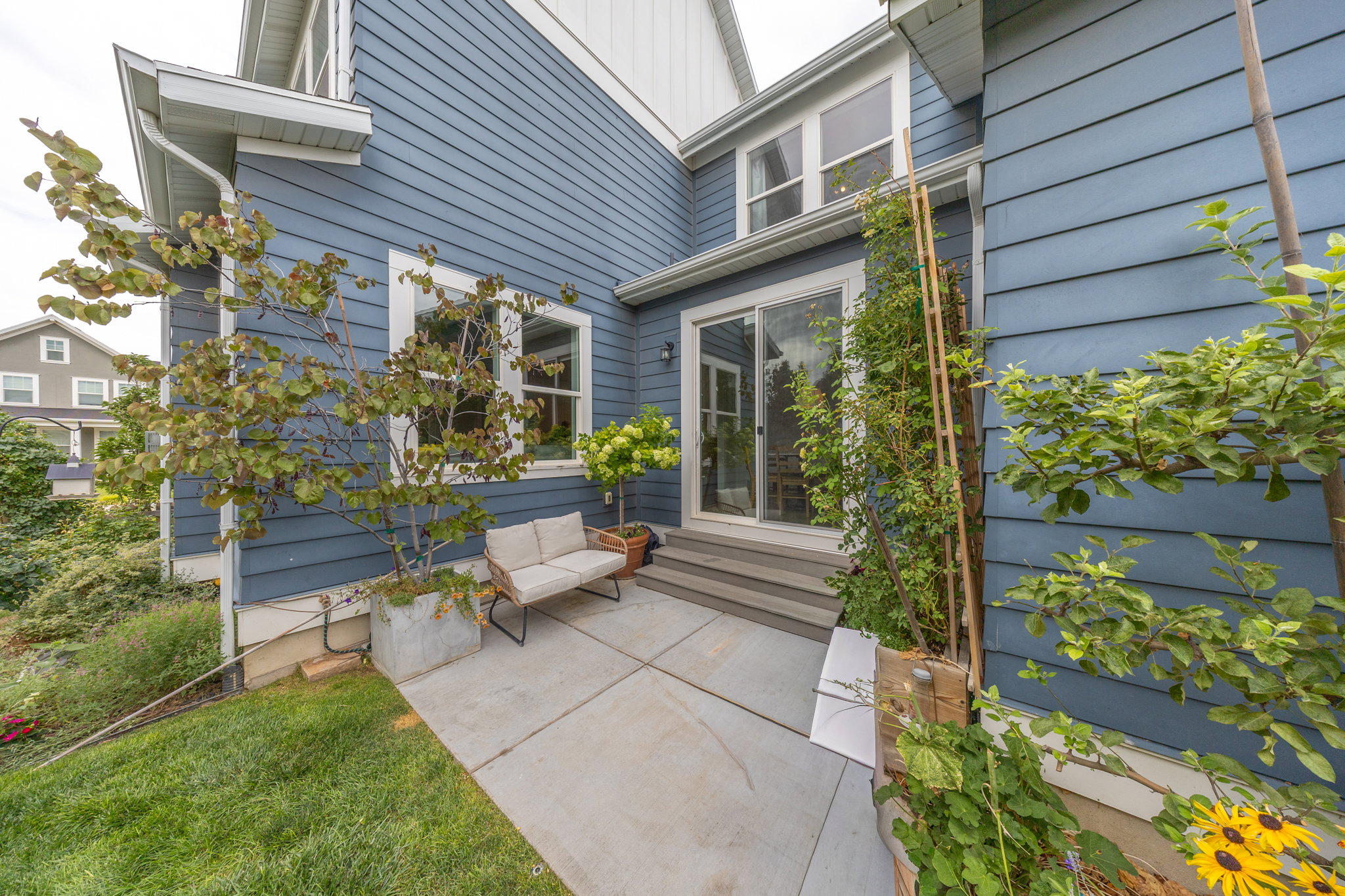 Exterior featuring blue horizontal siding and white trim