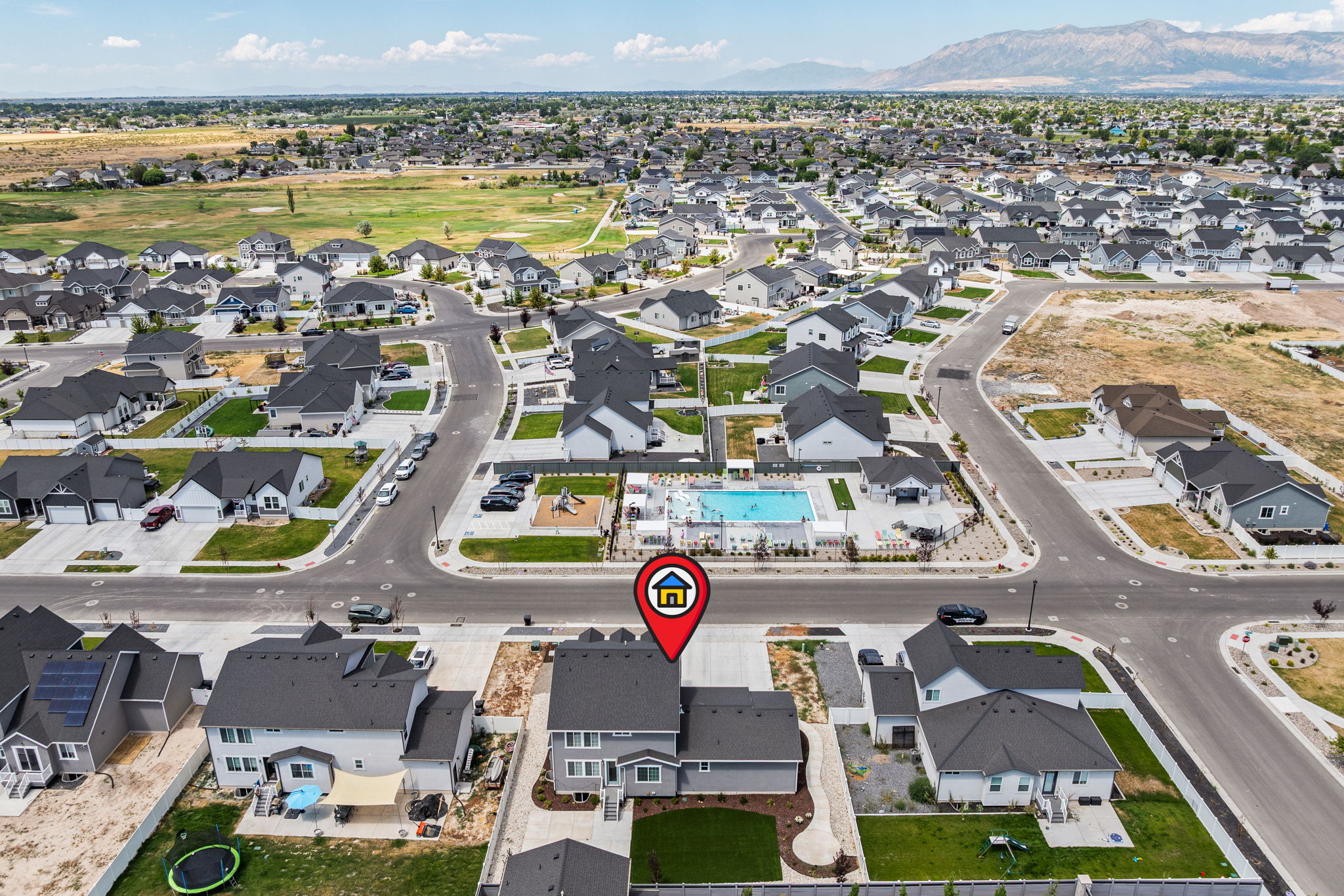 Contemporary residential development featuring a community swimming pool, playground, and paved streets