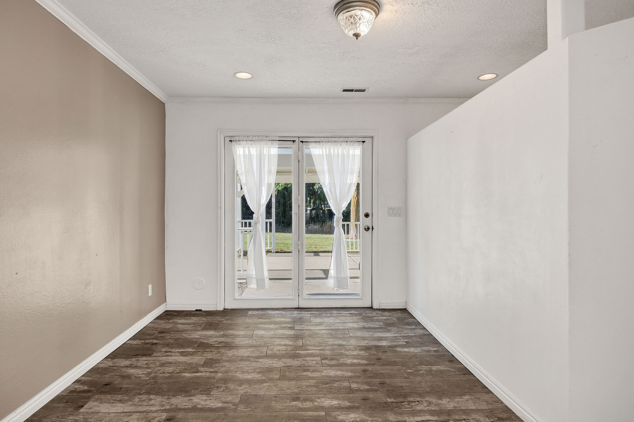 Glass paneled double doors with sheer white curtains