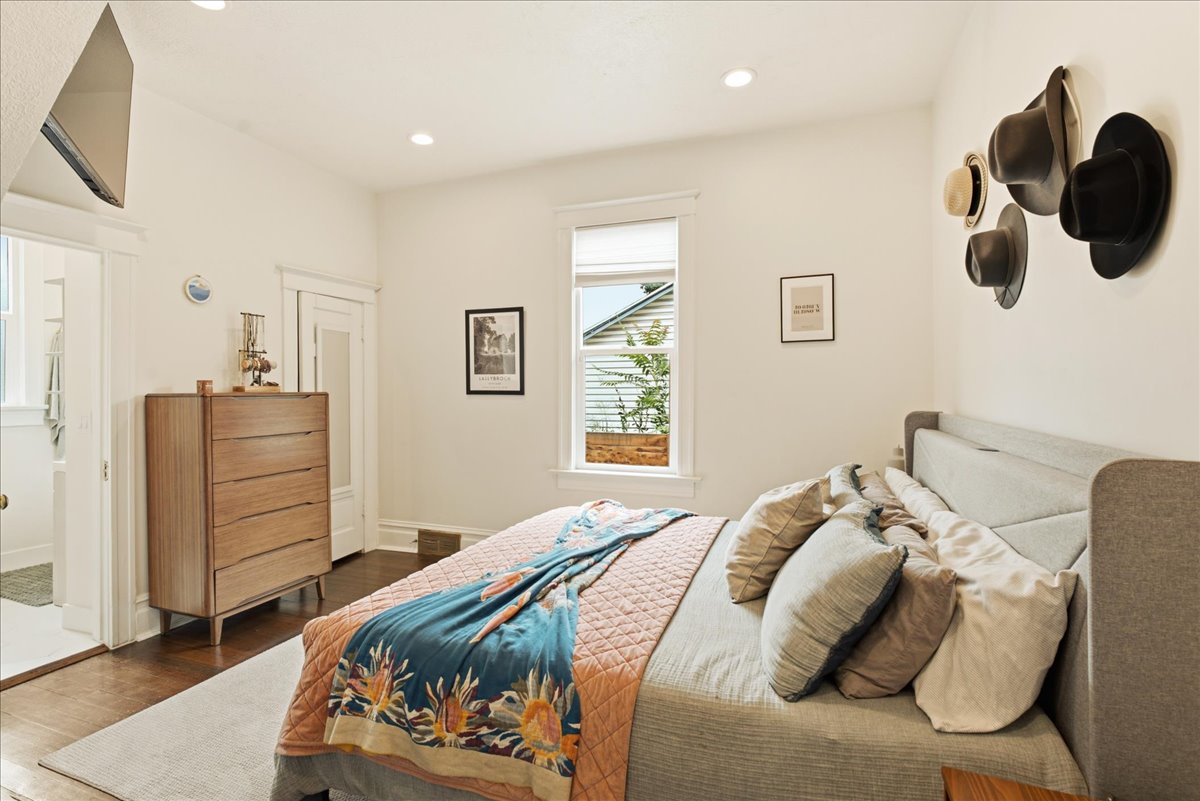 Hardwood flooring featuring an open doorway, recessed lighting, and a window with blinds