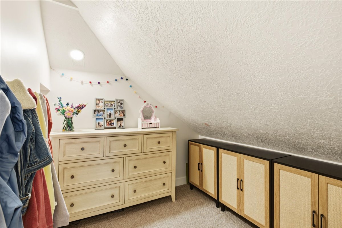 Built-in storage solutions featuring multiple closed cabinets with wood-finish doors and dark countertops