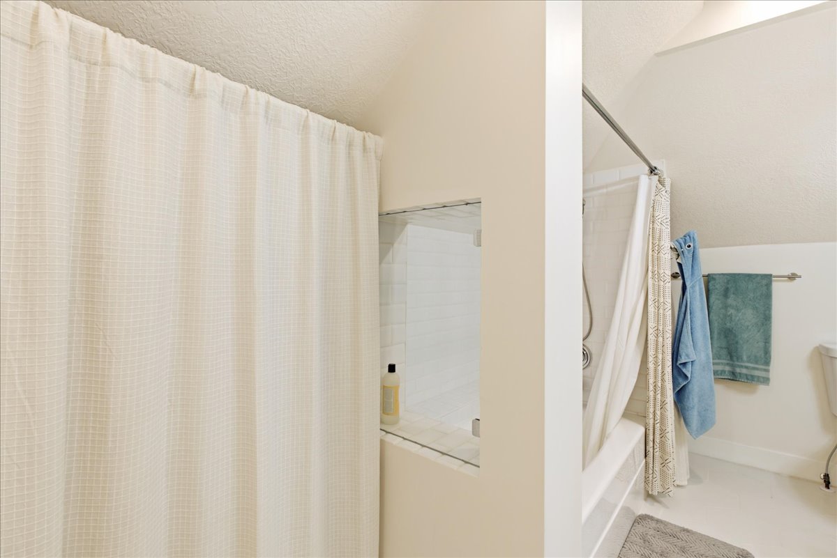 White grid-patterned shower curtain concealing a shower/tub combination