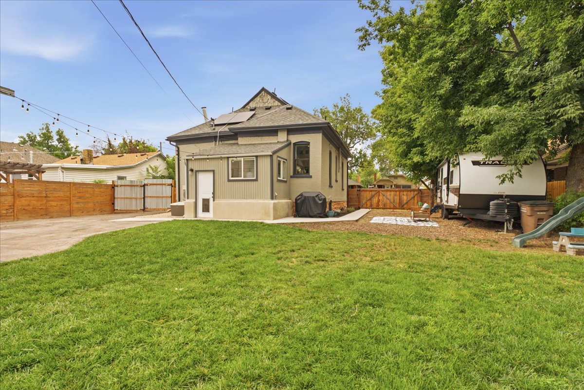 Expansive green lawn with a privacy fence bordering the property