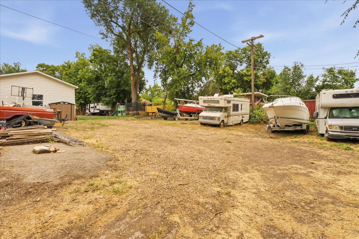 Expansive gravel and dirt lot offering ample space
