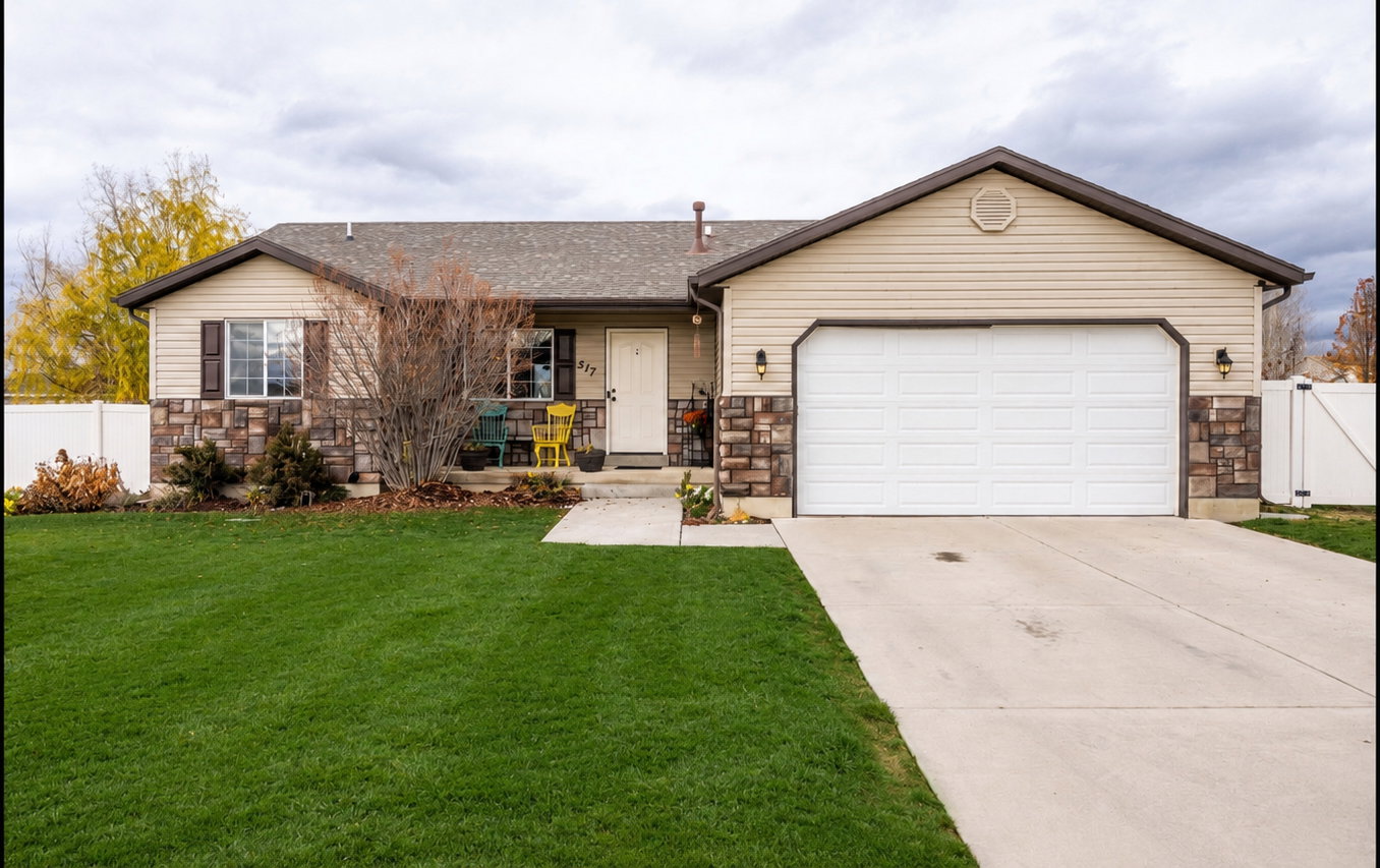 Ranch-style residence featuring a two-car garage, concrete driveway, and full vinyl fencing