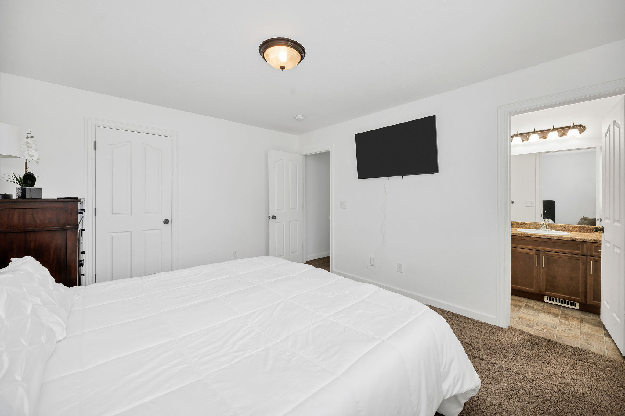 Bedroom space featuring a recessed light fixture and carpet flooring