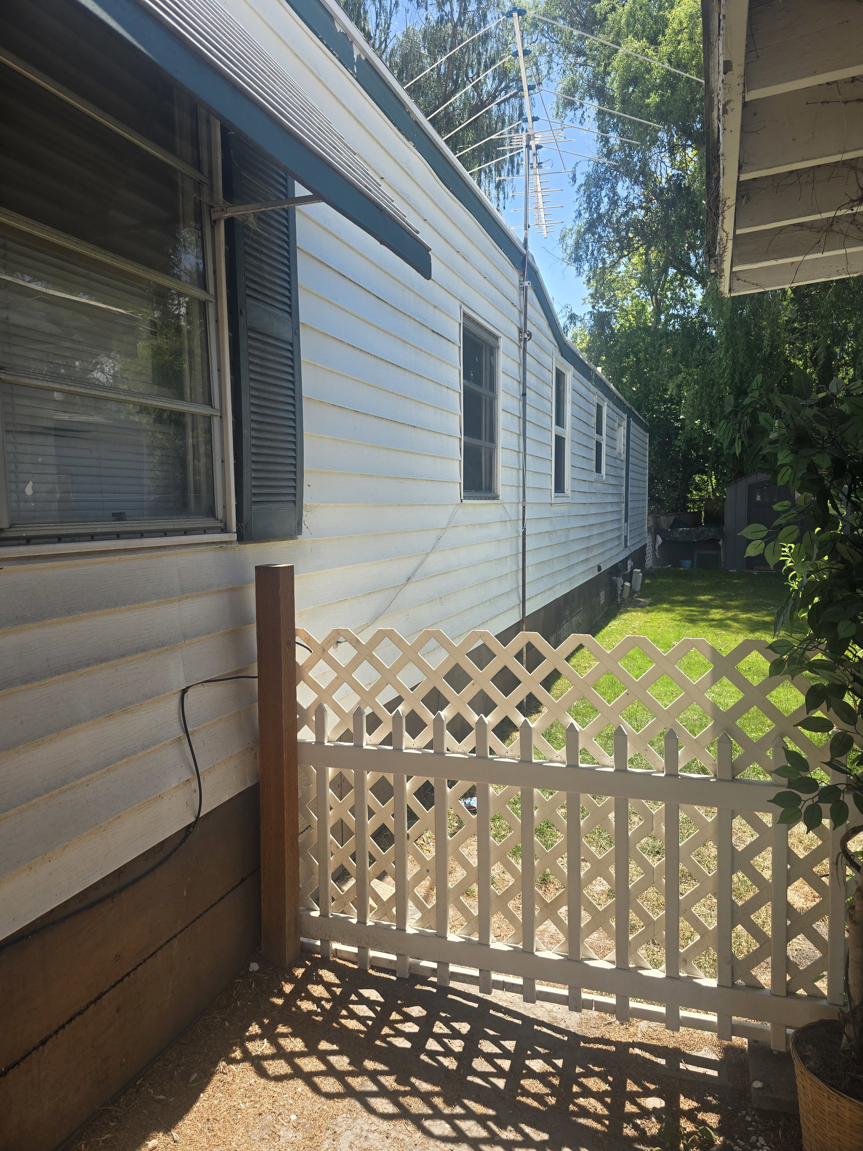 Exterior siding with louvered shutters and window awning