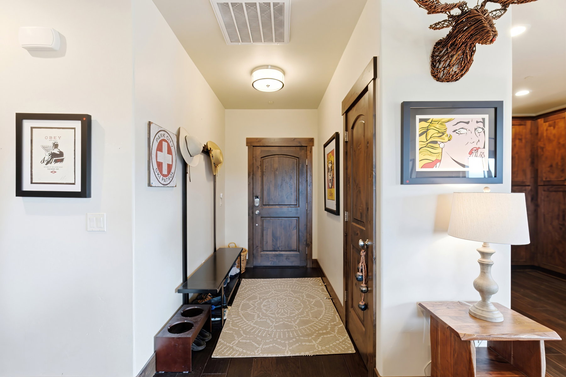Entryway featuring a wood-panel door, dark wood-finish flooring, recessed lighting, and a contemporary ceiling fixture