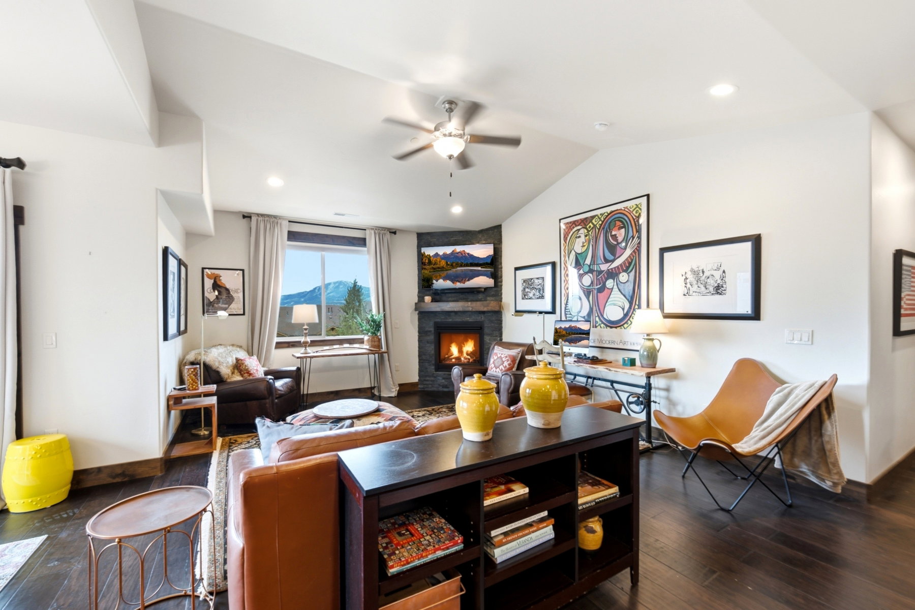Vaulted ceilings with exposed beams complement the dark wood-finish flooring