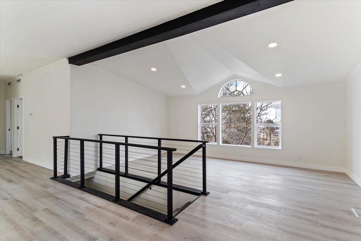 Vaulted ceiling with an exposed beam and recessed lighting