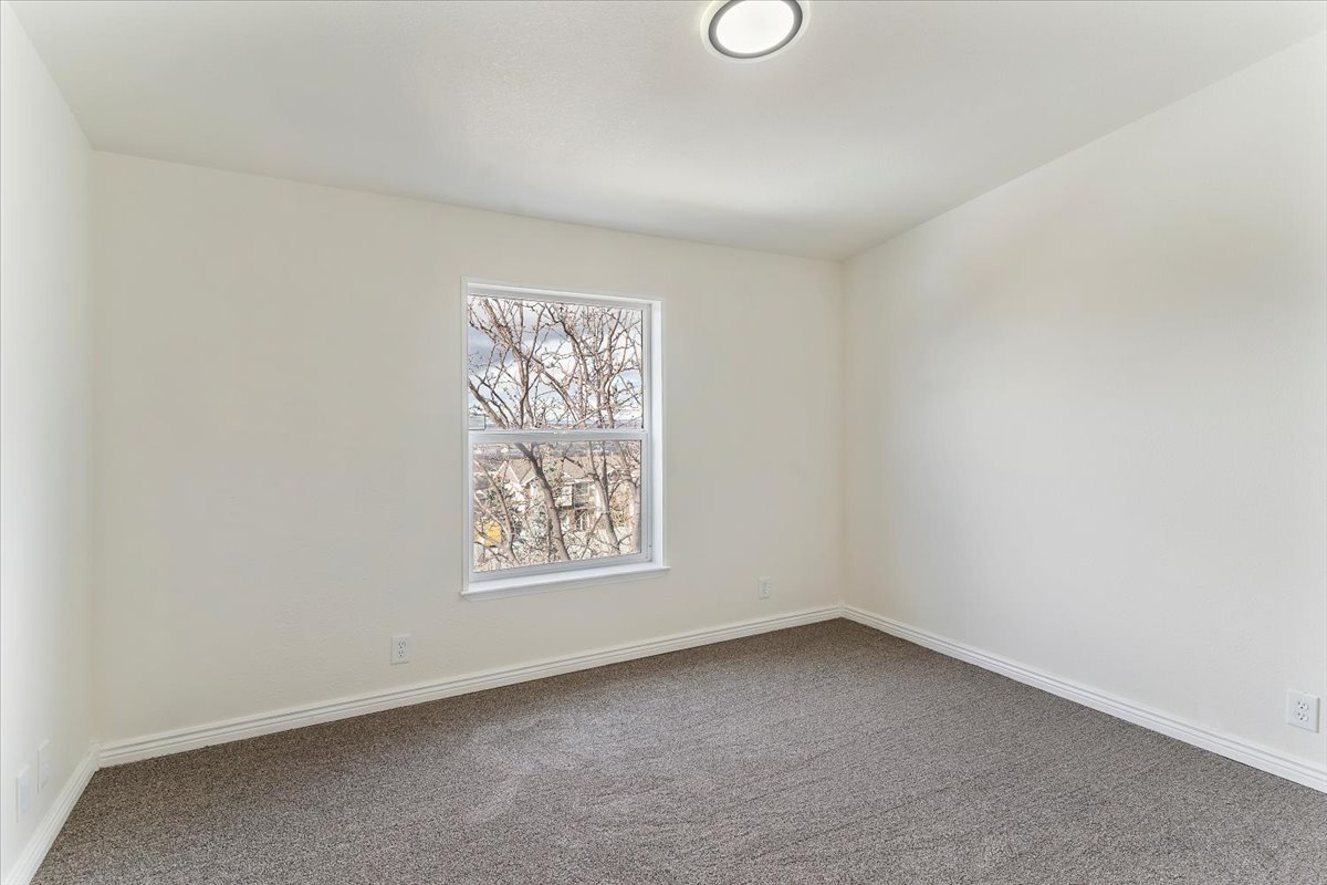 Neutral wall colors with white trim and a single window