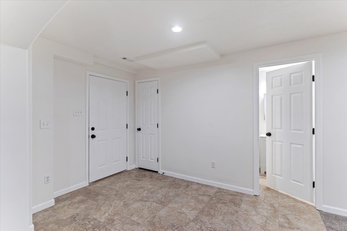 Room featuring tiled flooring, white painted walls, and recessed lighting