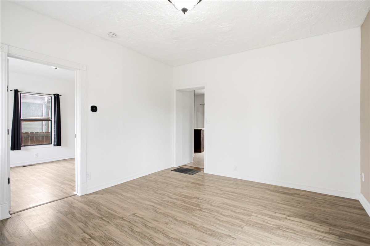 Bright interior space featuring light wood-finish flooring, white painted walls, and white trim