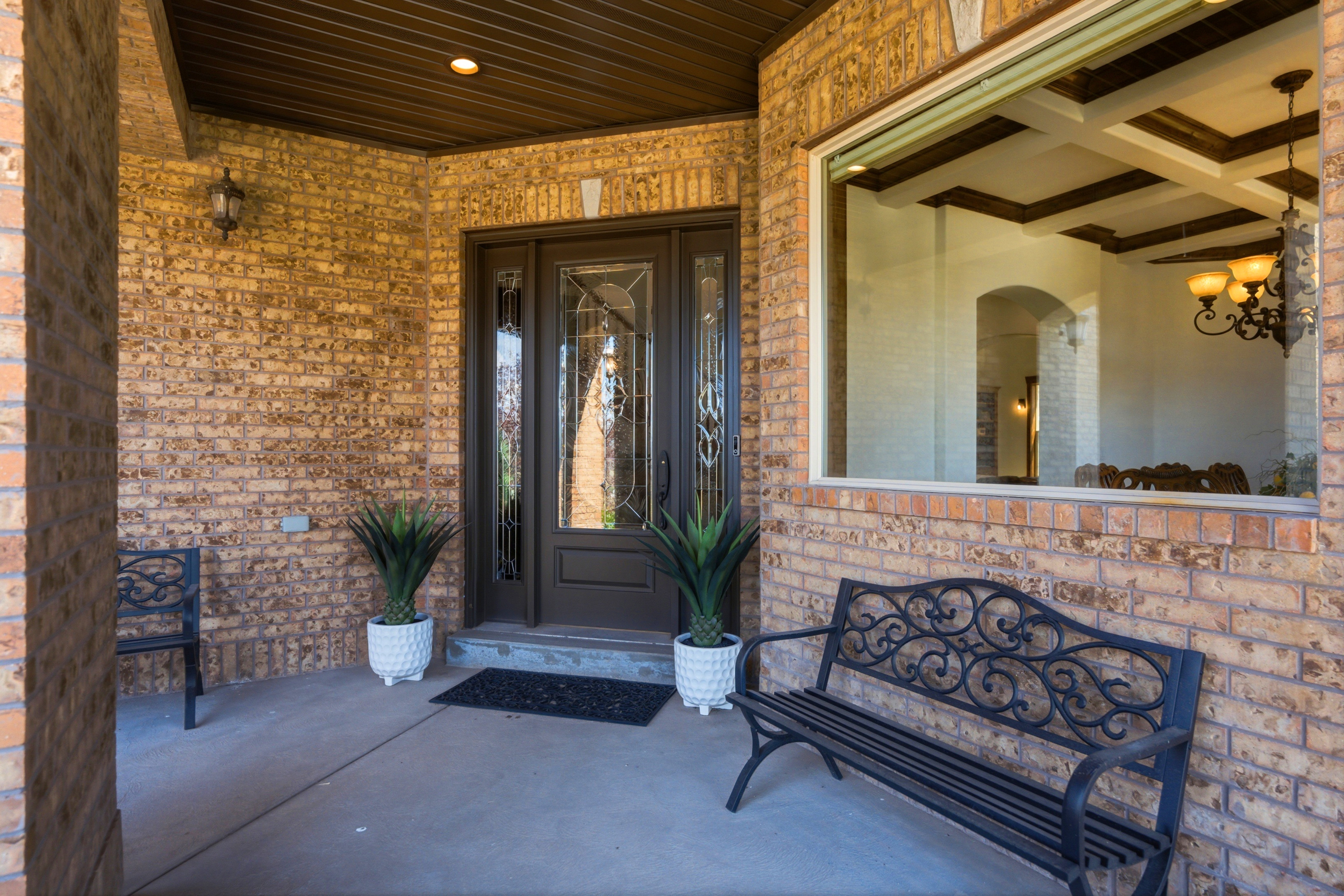 Brick exterior with a covered entryway and a prominent window