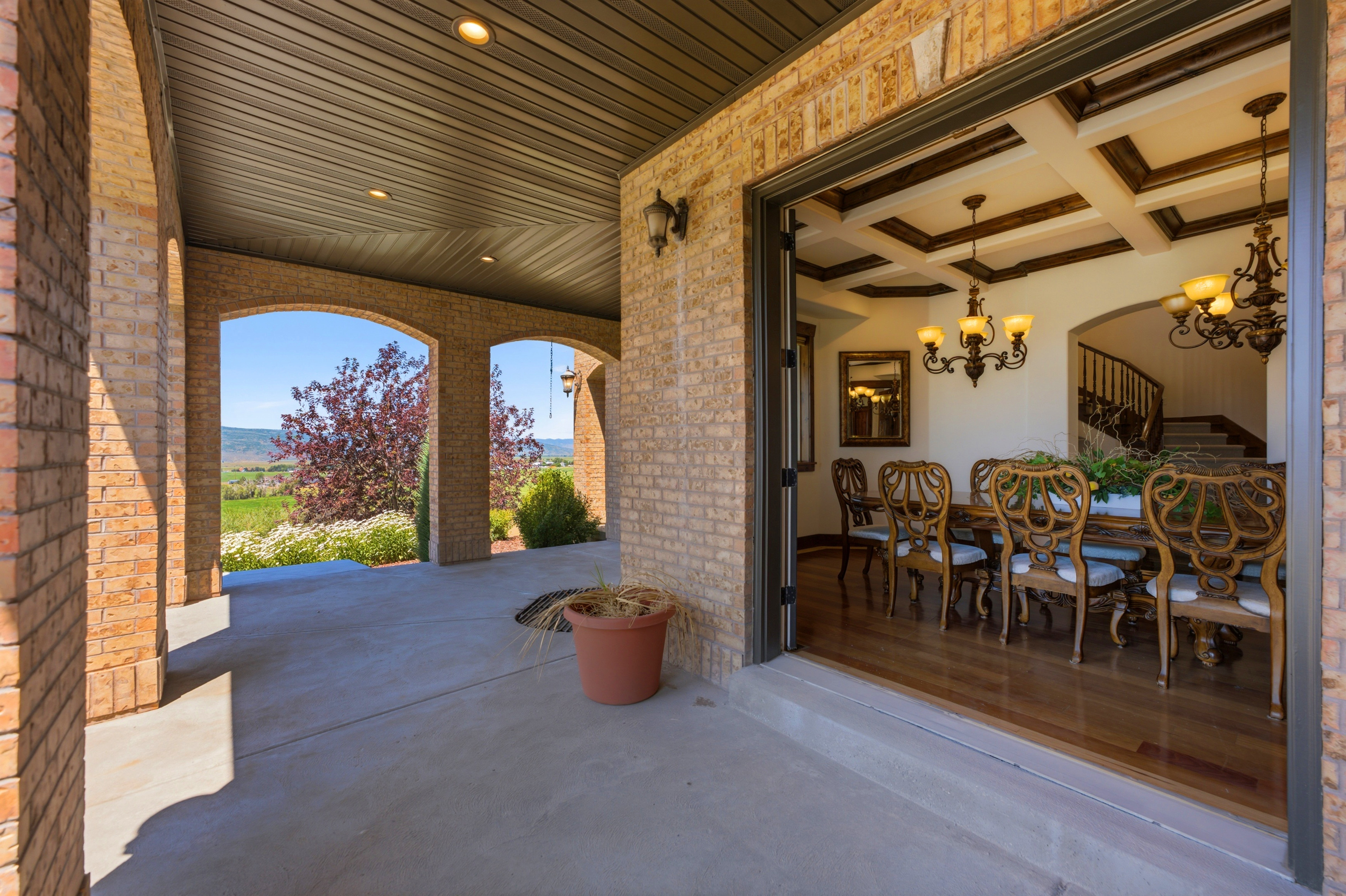 Brick archway patio with a coffered ceiling