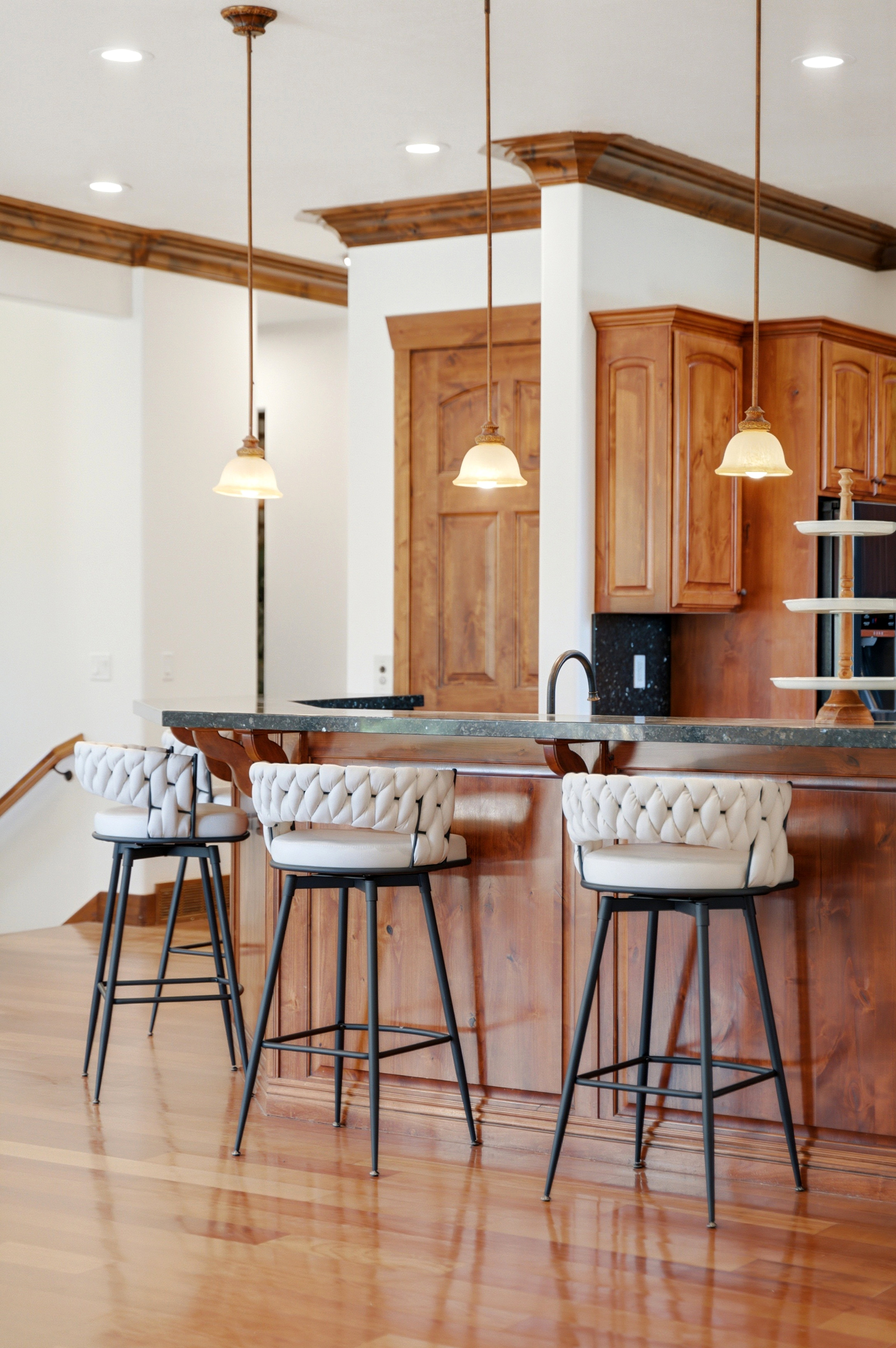 Kitchen island with a dark countertop and rich wood-finish cabinetry