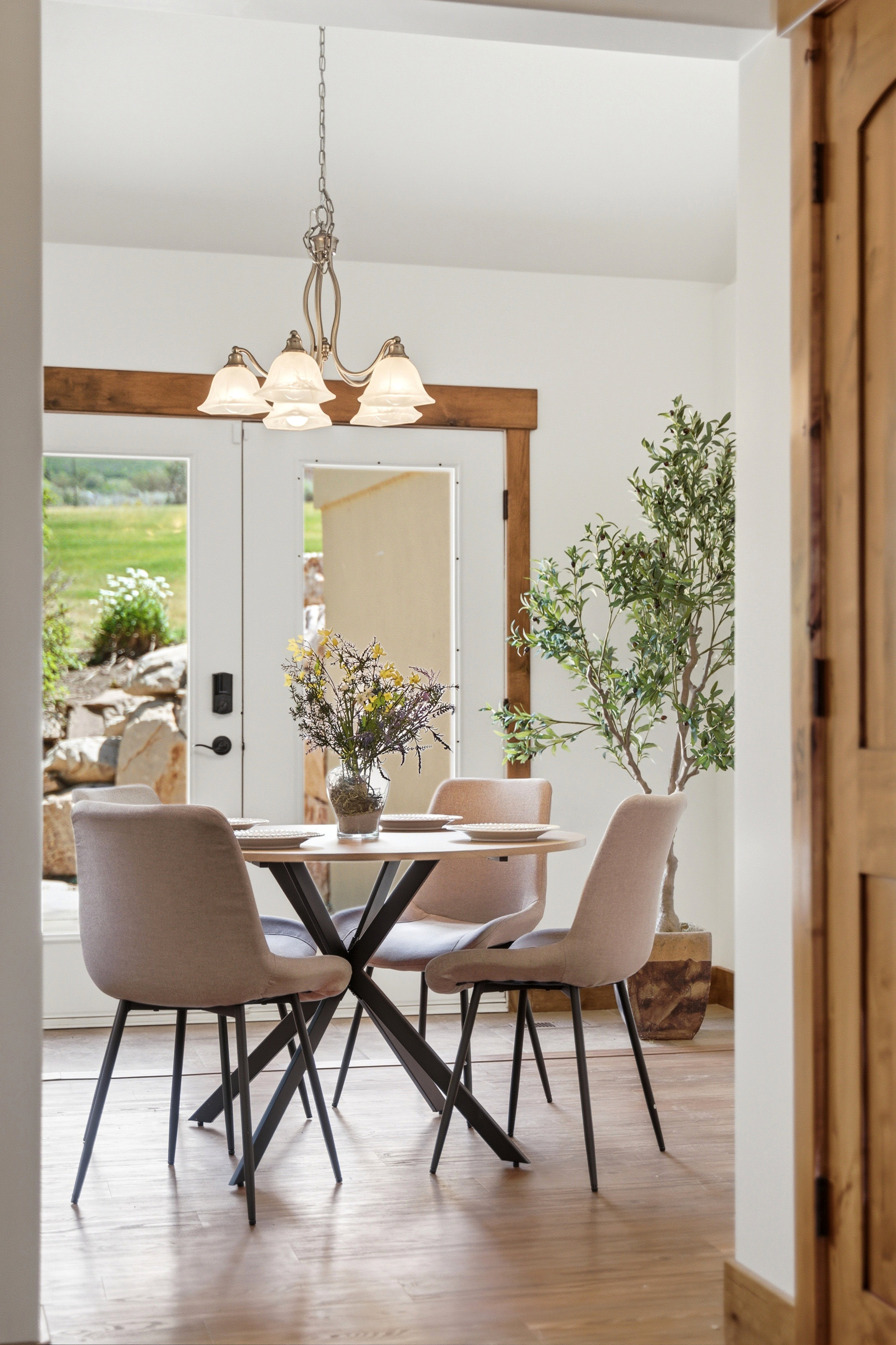 Light wood-finish flooring with white walls and natural wood trim