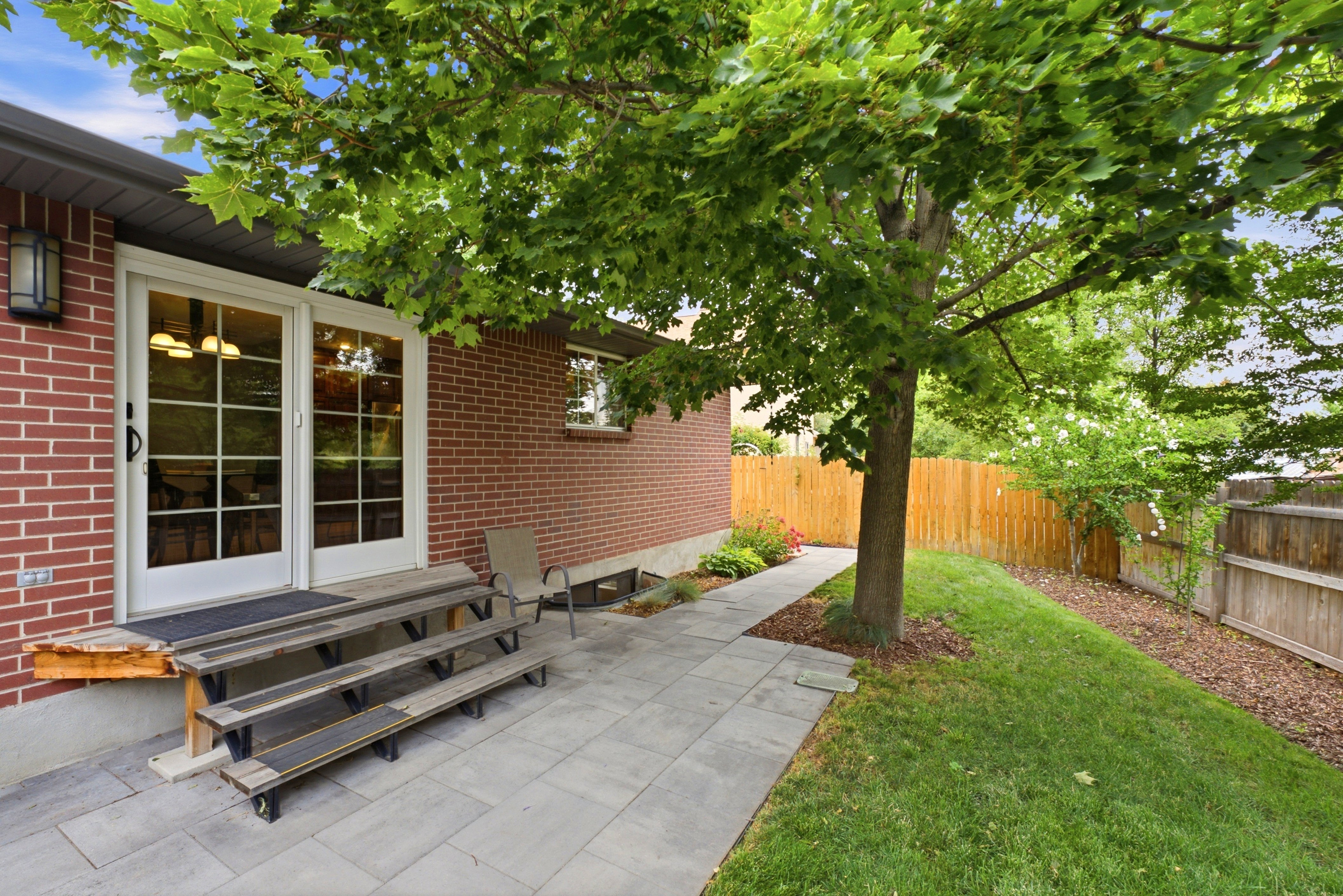 Red brick exterior featuring white paneled double doors with transom windows.