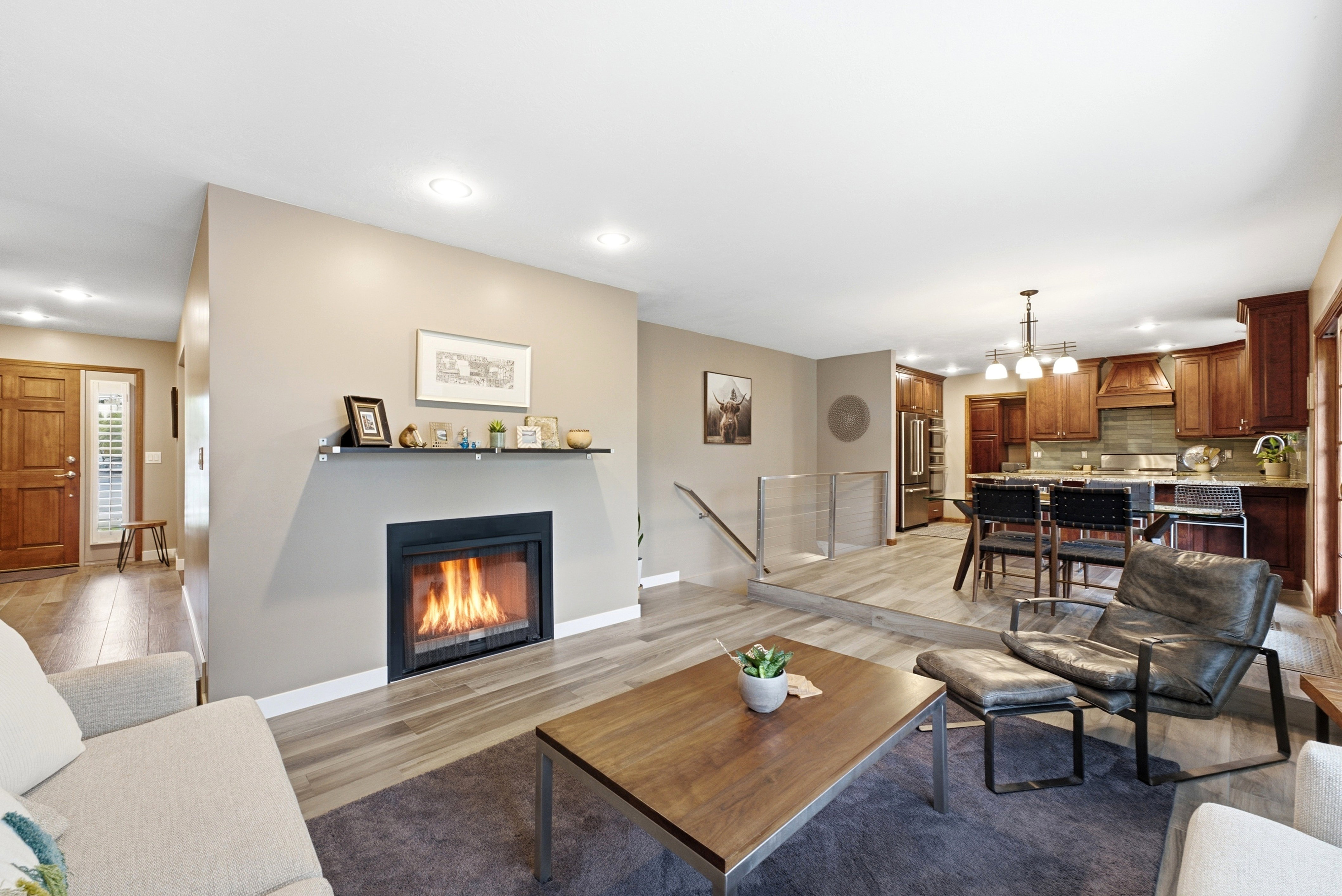 Living area featuring a modern fireplace with a floating mantel shelf, and recessed lighting.