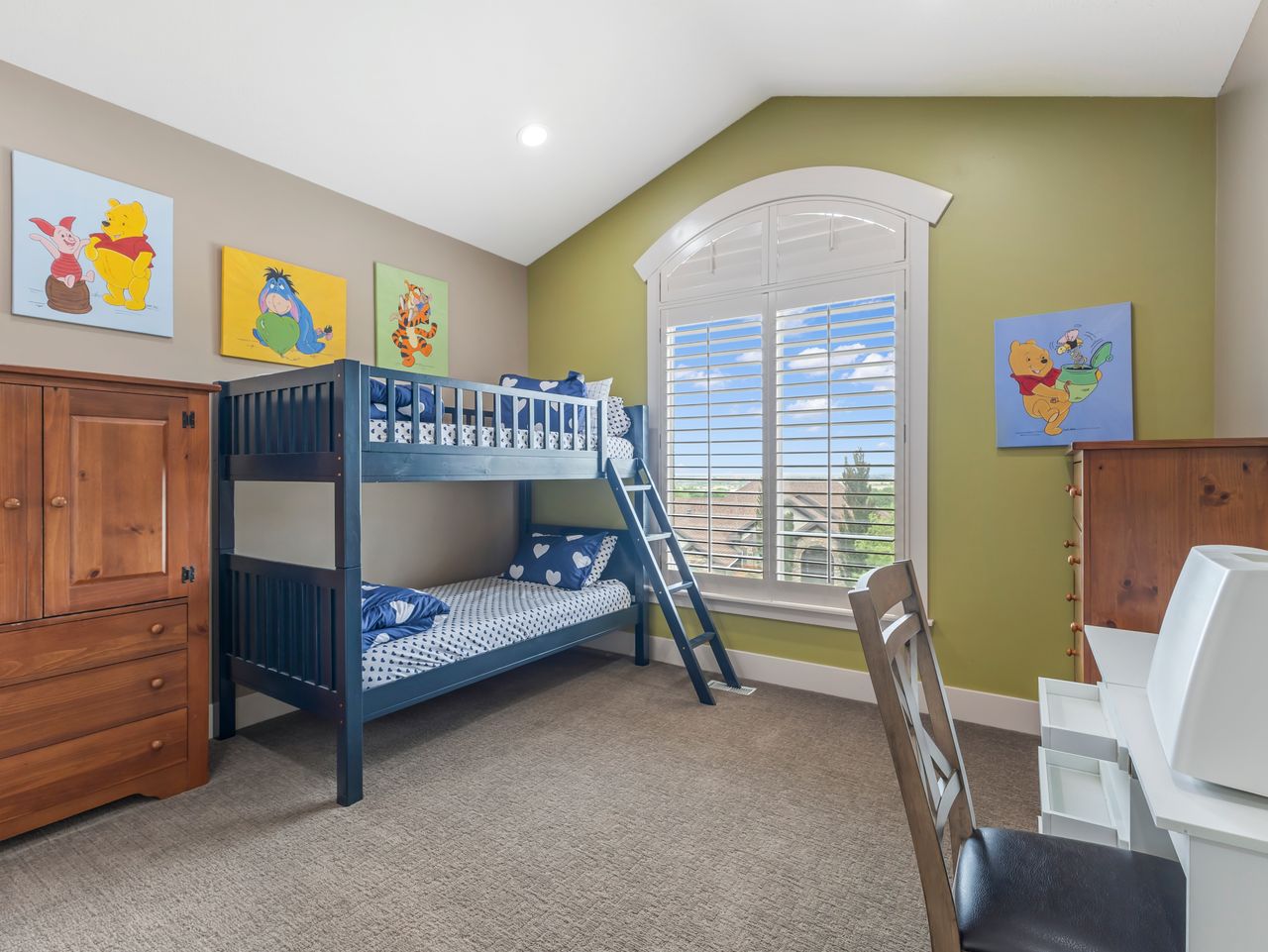 Arched window featuring plantation shutters and exterior views