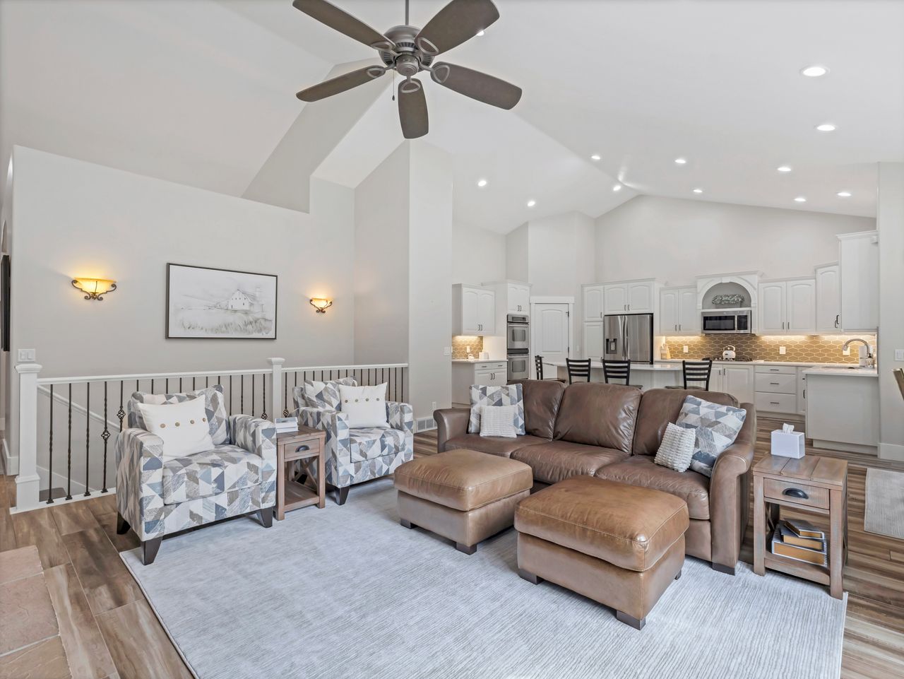 Open-concept living area featuring vaulted ceilings, recessed lighting, and a contemporary ceiling fan
