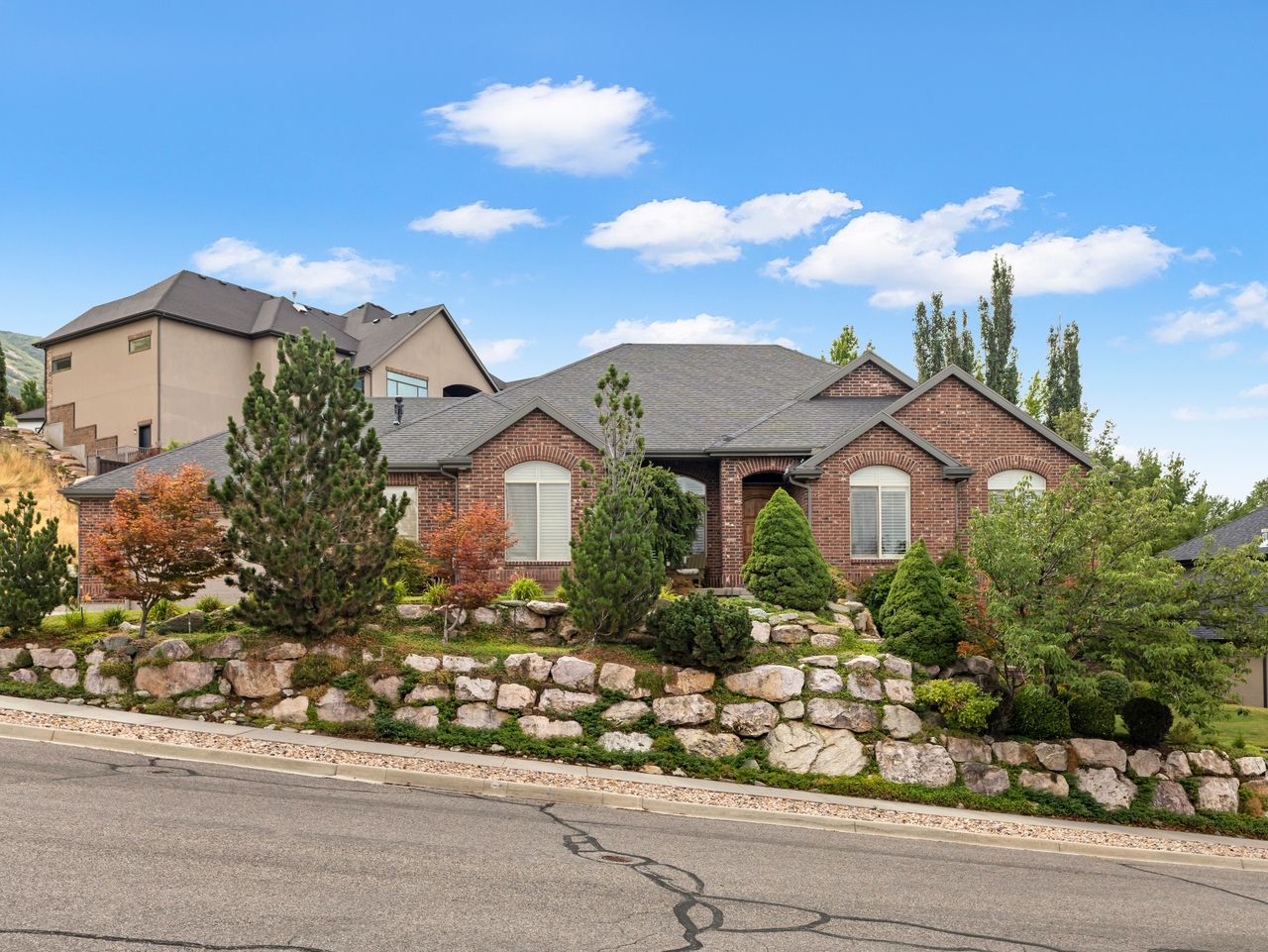 Traditional brick exterior with arched windows and a dark shingled roof