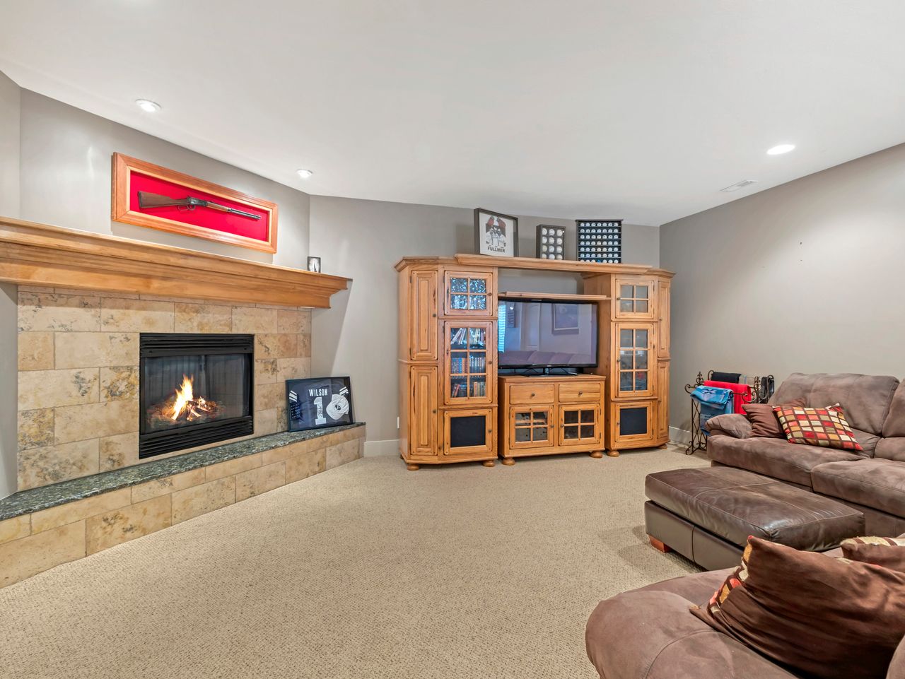 Corner fireplace with a stone surround, a wood mantel, and a stone hearth with a dark countertop