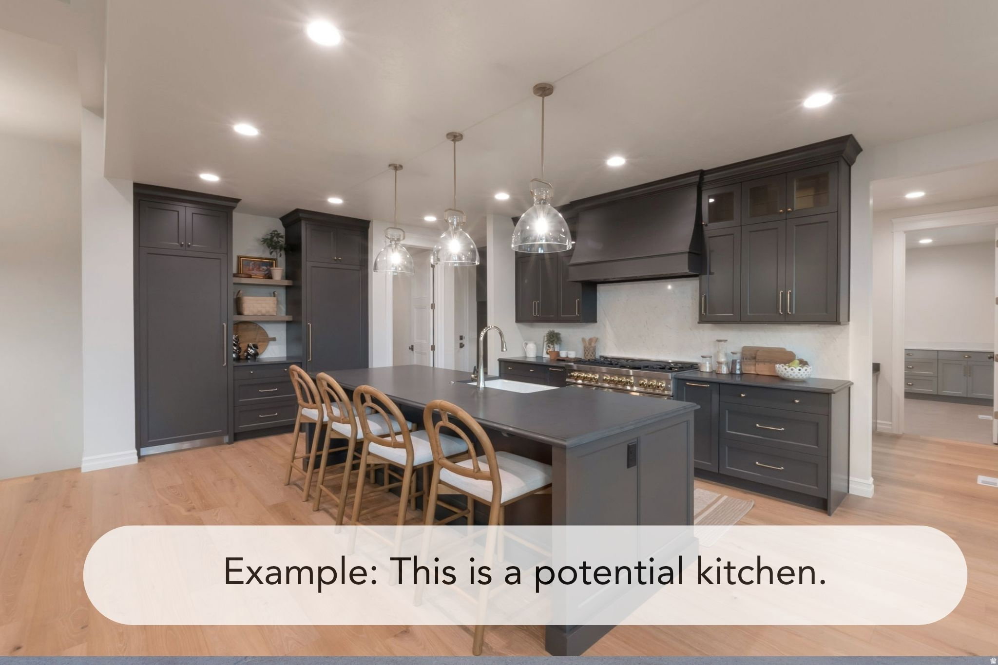 Spacious kitchen featuring dark cabinetry, a large central island with seating, pendant lighting fixtures, a white tile backsplash, and wood-finish flooring