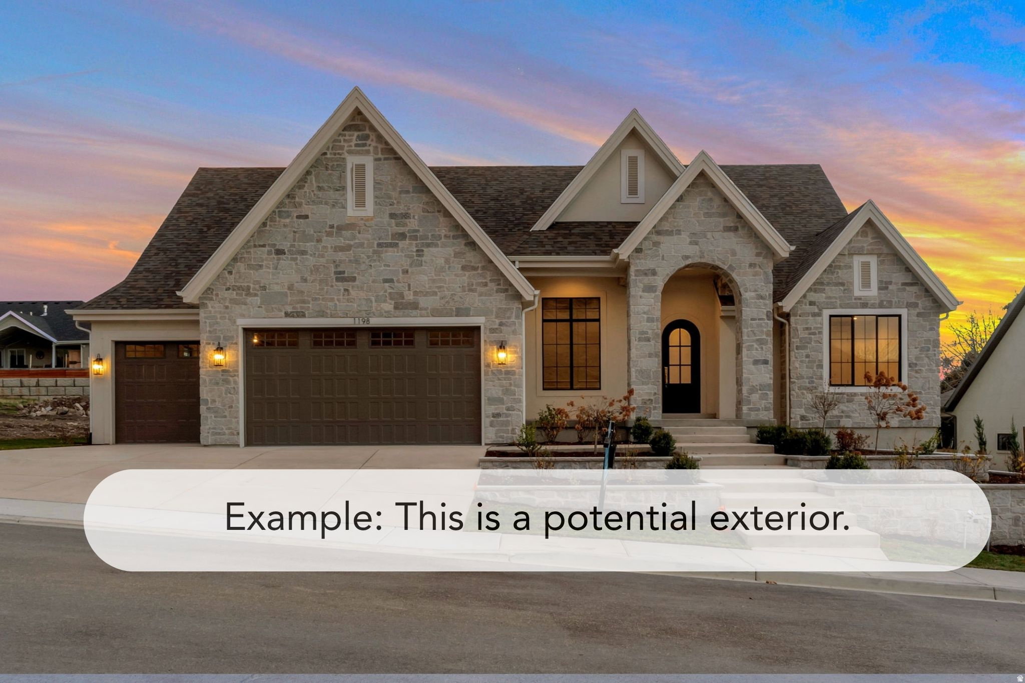 Stone and stucco exterior featuring multiple gables and a prominent arched entryway