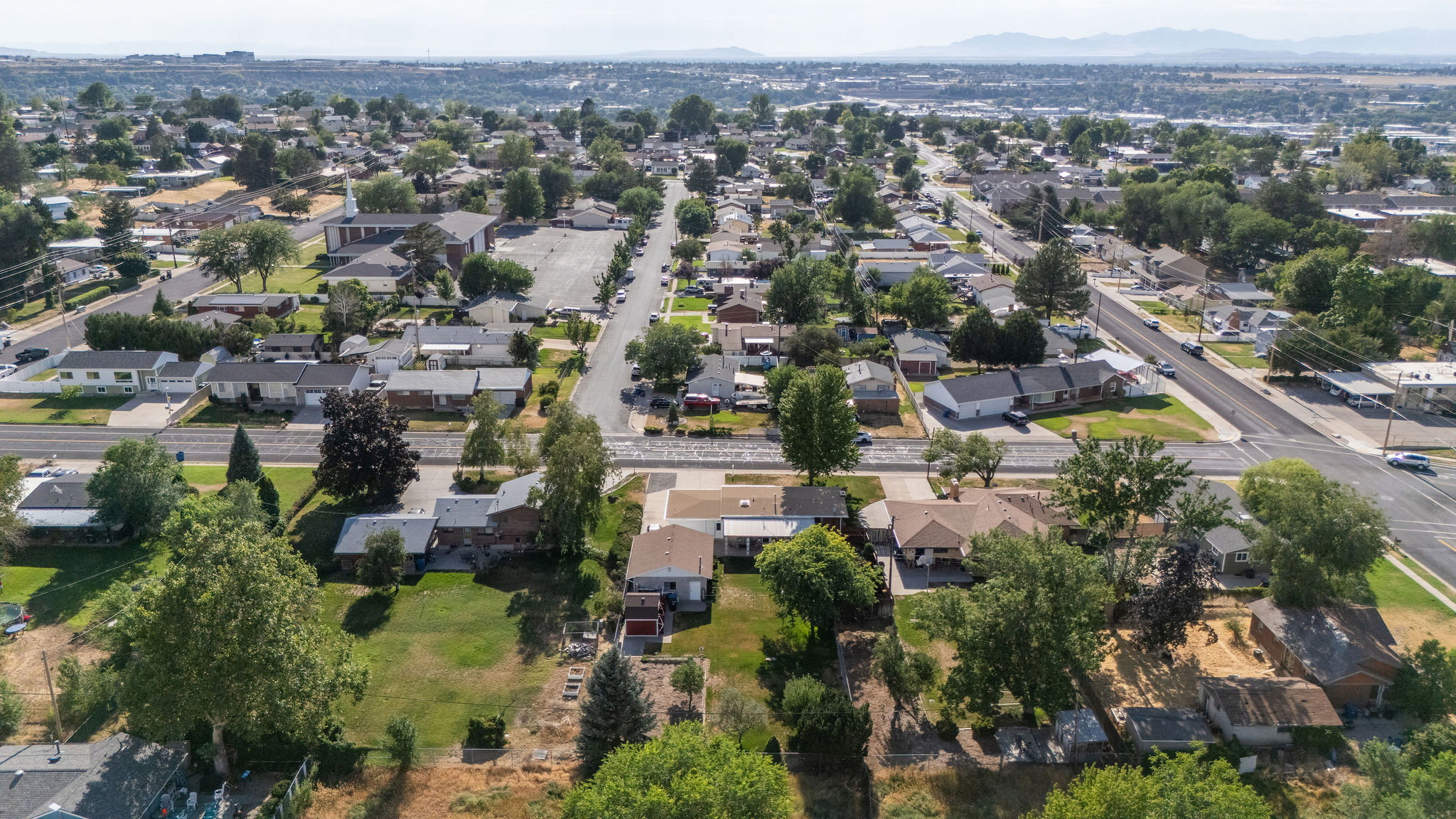 Aerial perspective showcasing a residential area with varied housing styles and established tree cover