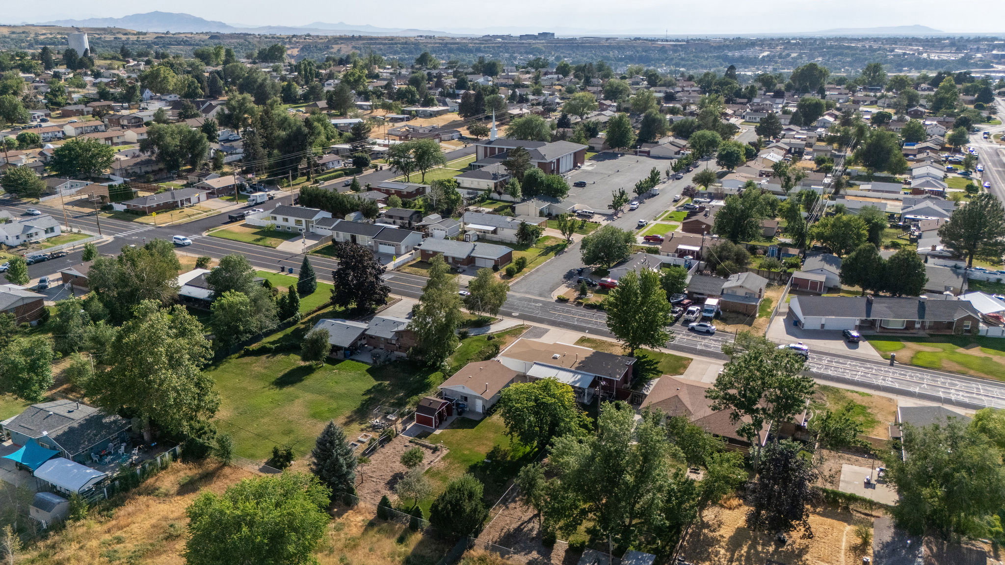 Aerial perspective showcasing a residential area with varied housing styles and mature tree cover