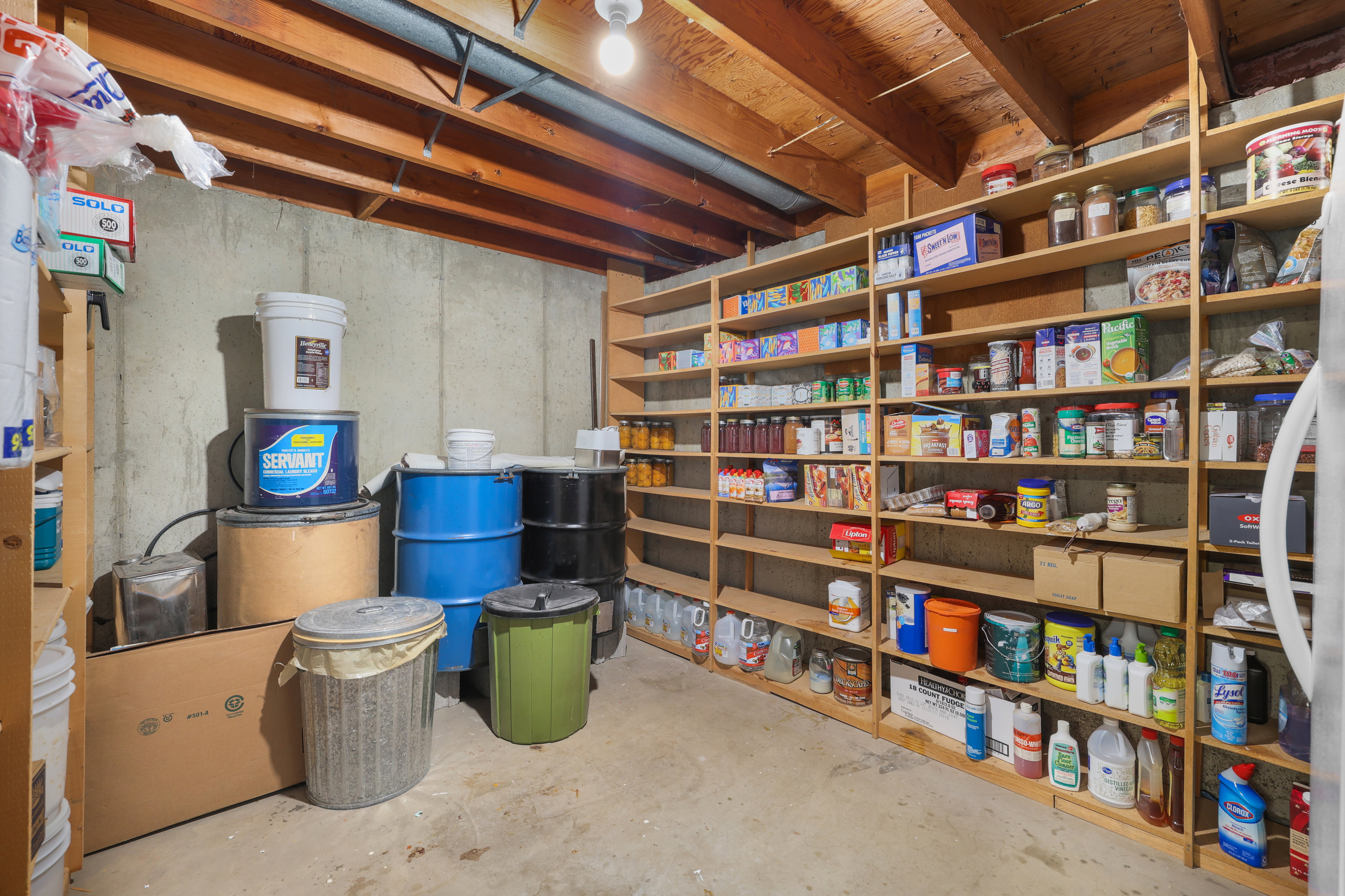 Basement storage area featuring extensive built-in wooden shelving for organization