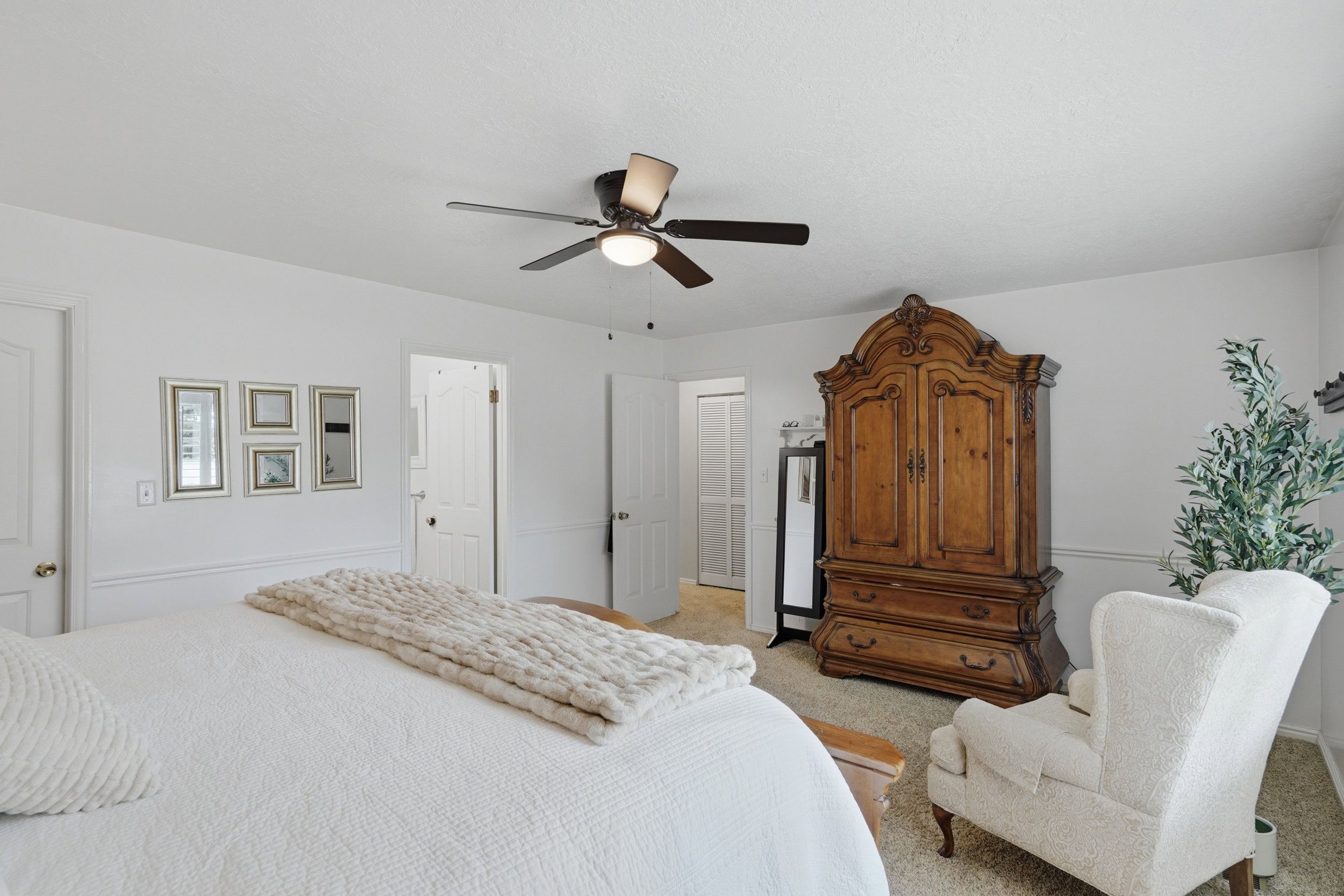 Bright room featuring light-colored walls and carpeted flooring