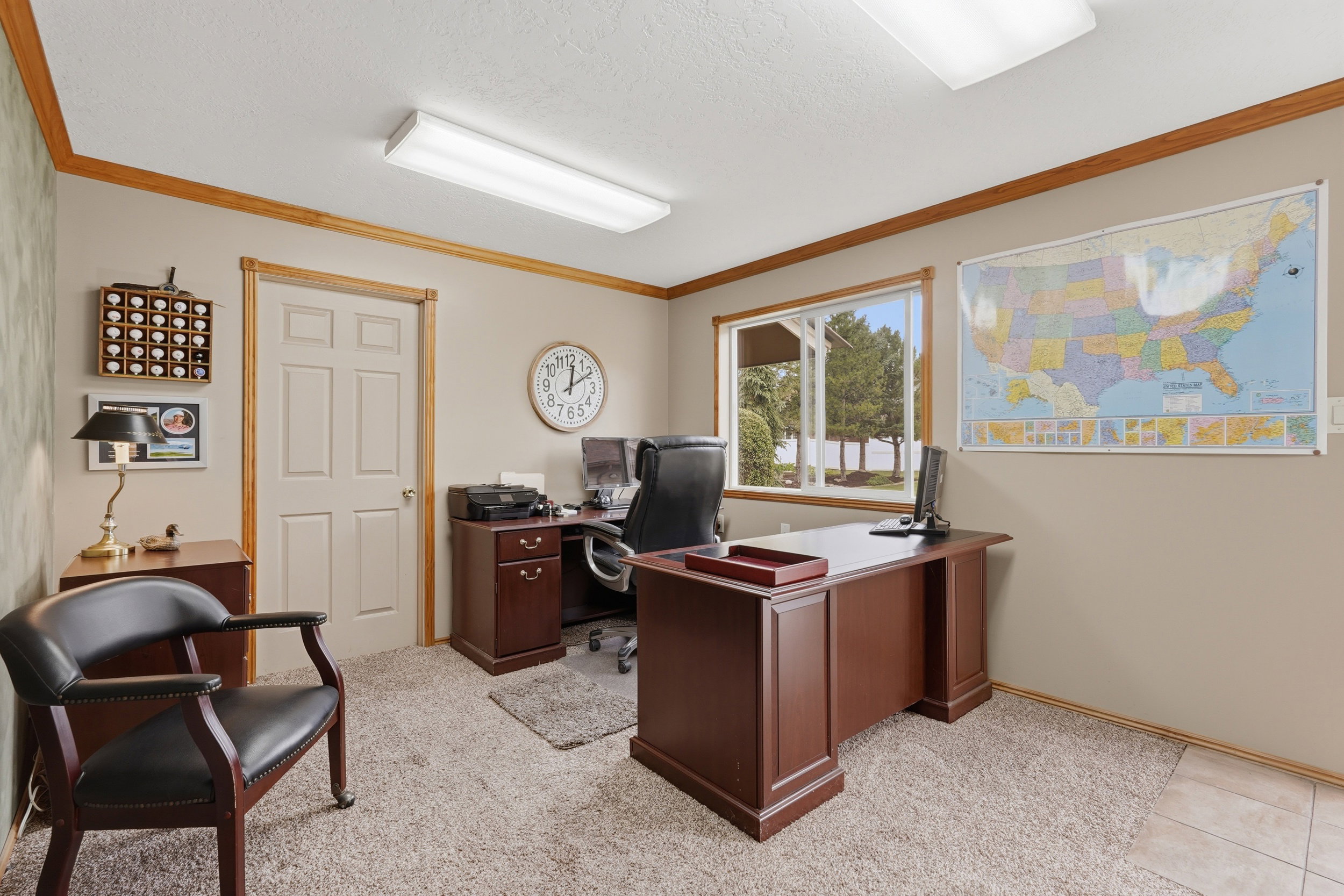 Detached separate flex space. Carpeted room with a multi-pane window, wood trim, and a paneled door that's heated and cooled with fiber.