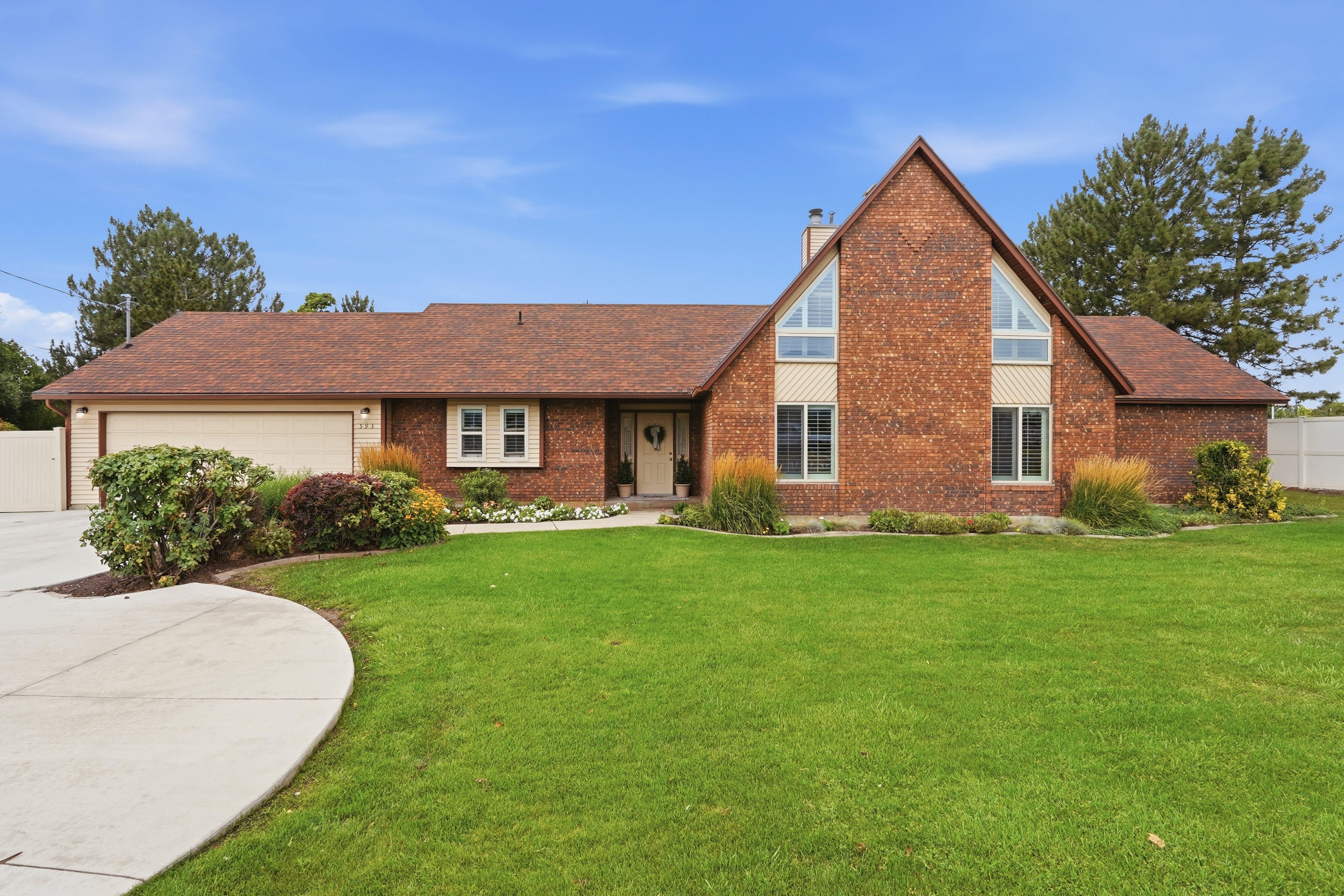 Brick exterior featuring an A-frame architectural element and a brown shingle roof