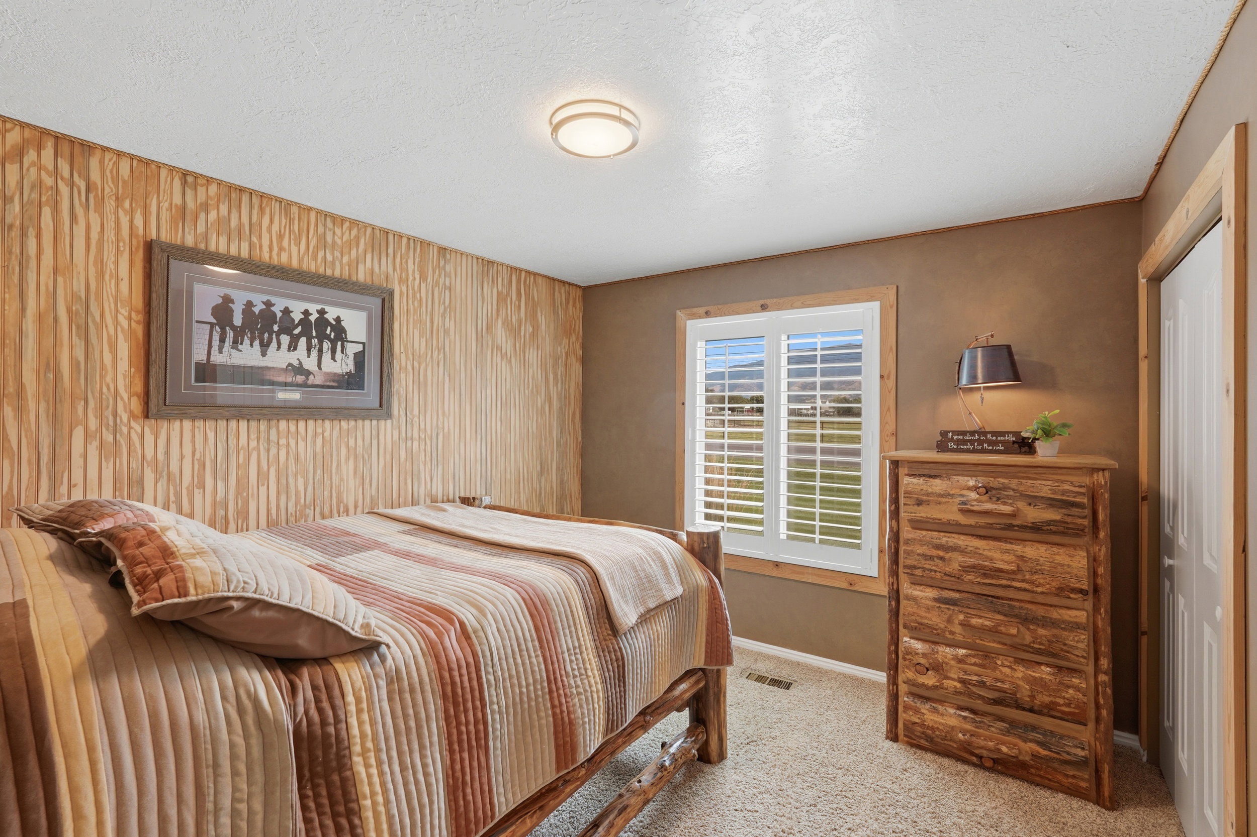 Textured wood paneling accent wall featuring a framed art piece