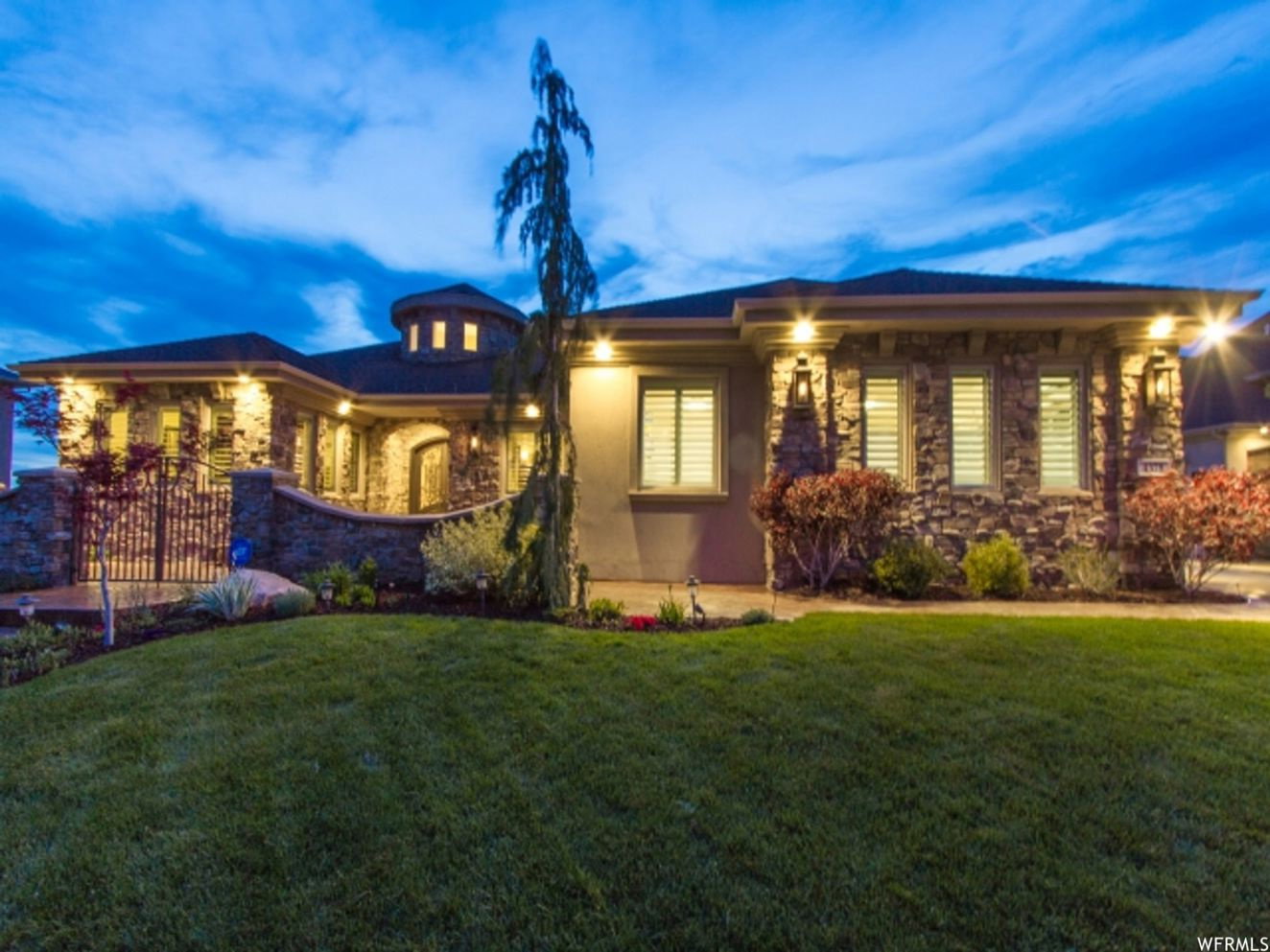 Stately stone and stucco exterior with a prominent turret feature