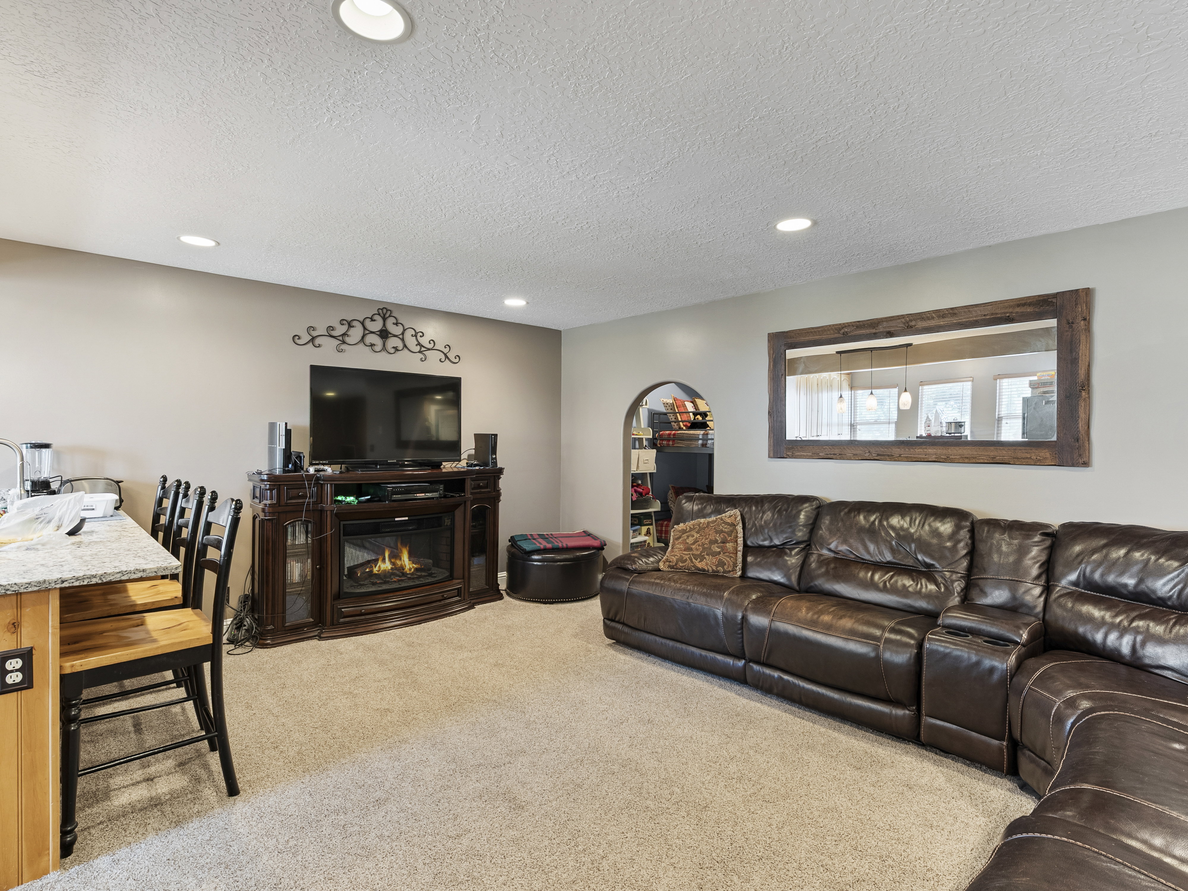 Carpeted living area featuring recessed lighting and a built-in fireplace