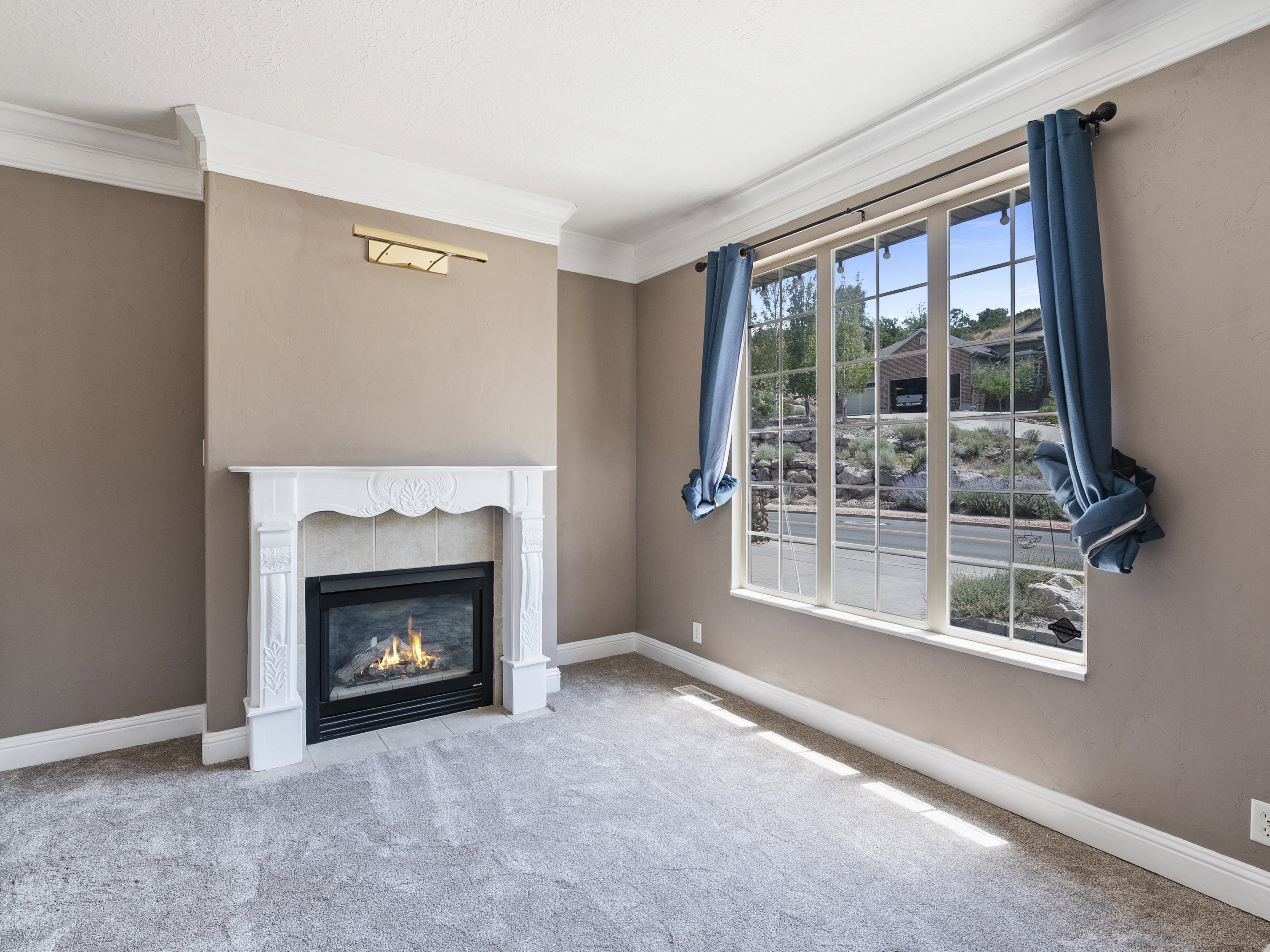 Fireplace featuring a decorative white mantel, tile surround, and an integrated gas insert