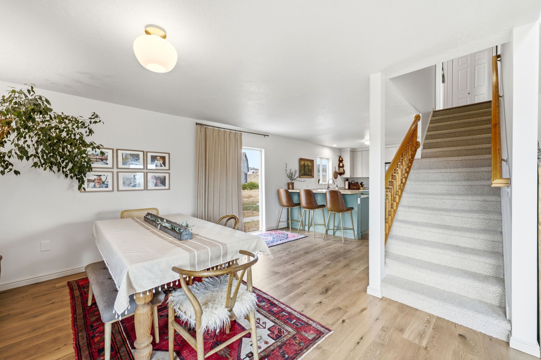 Open-concept living space with wood-finish flooring extending into the dining area