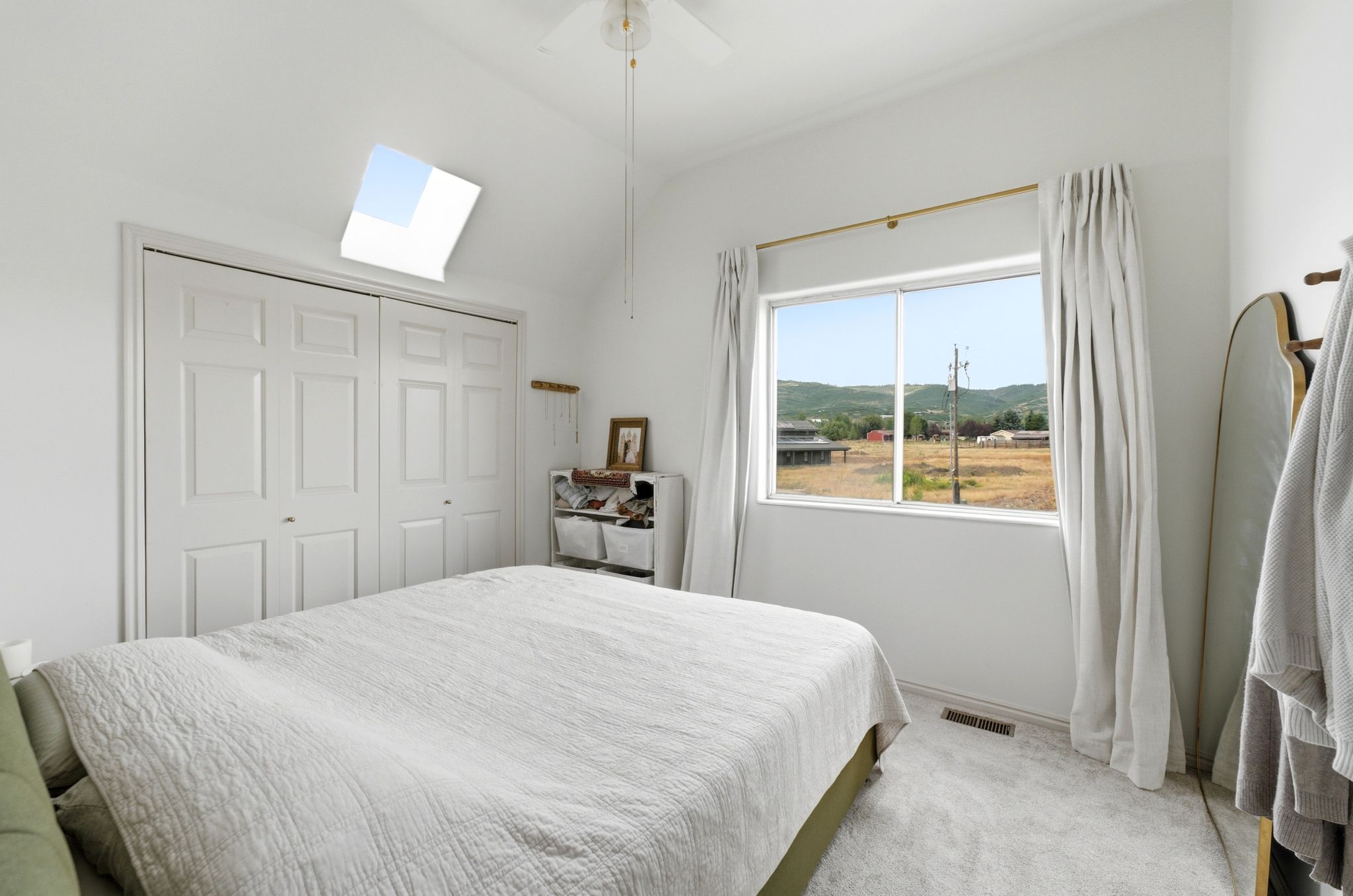 Vaulted ceiling with skylight and ceiling fan