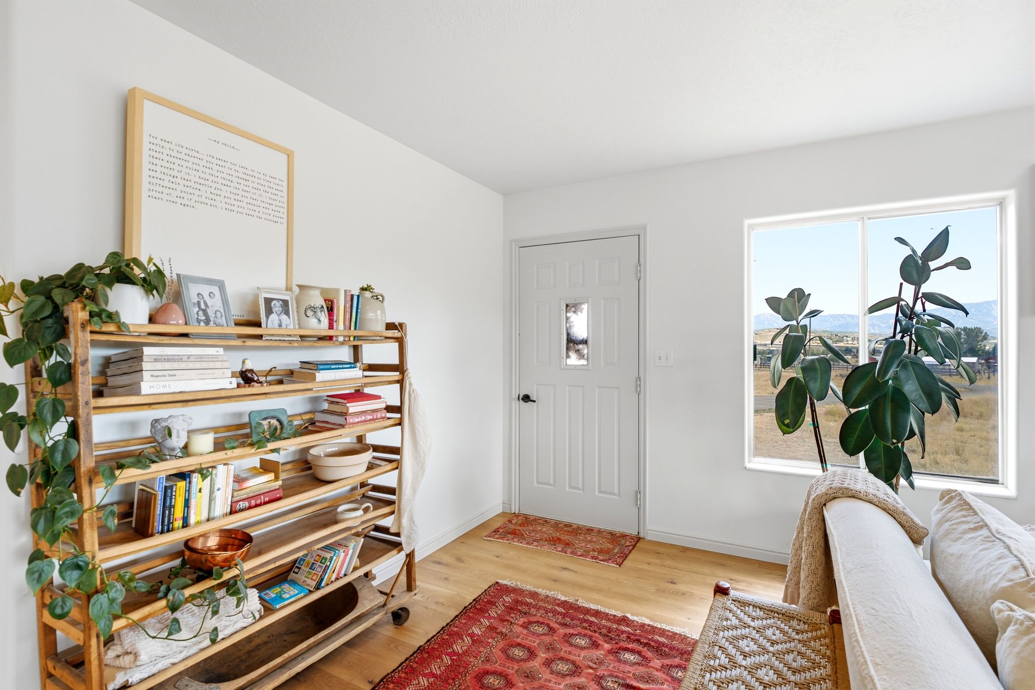 Light-toned wood-finish flooring complements white walls