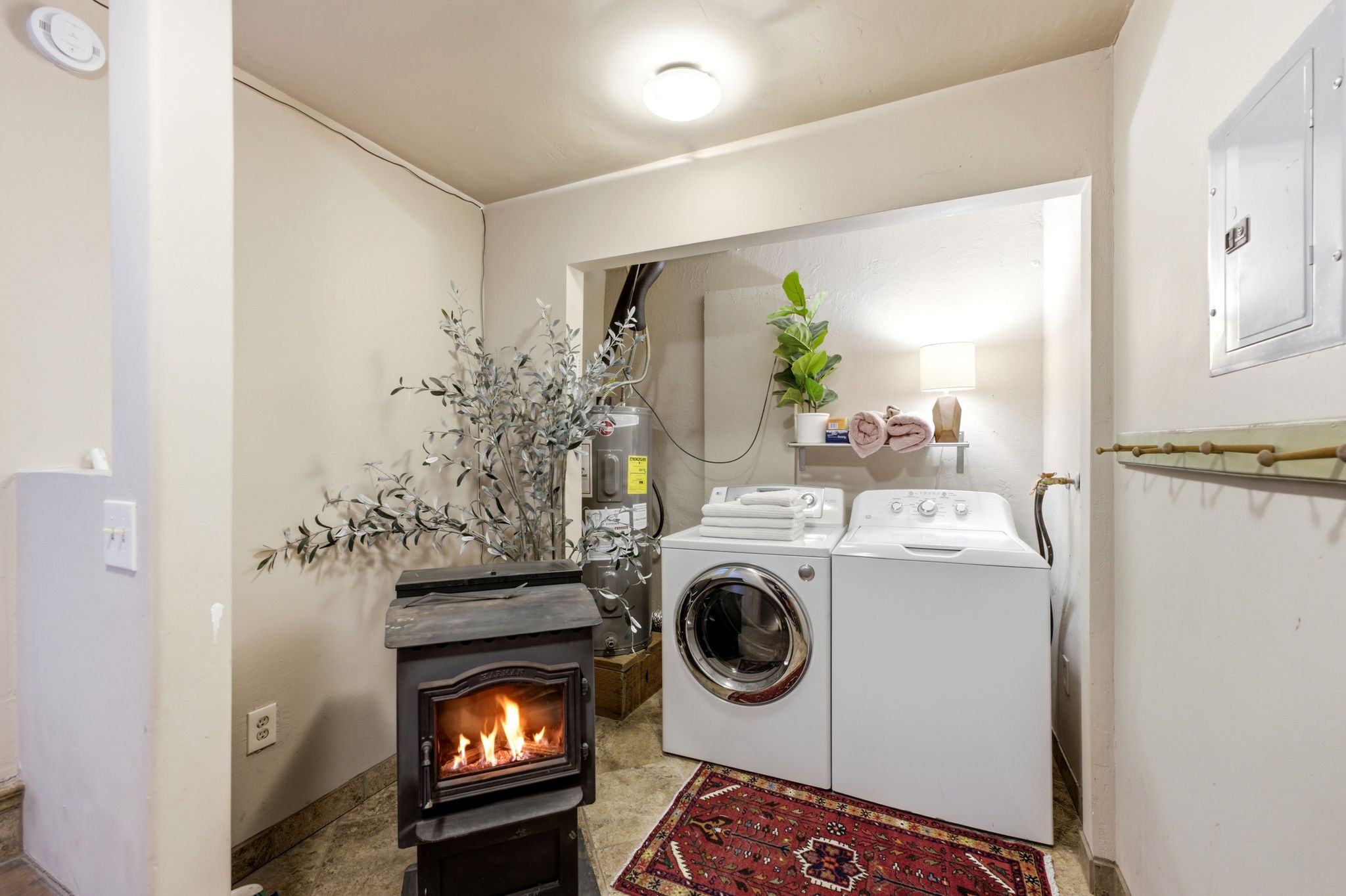 Dedicated laundry area featuring a front-load washing machine and a top-load washing machine