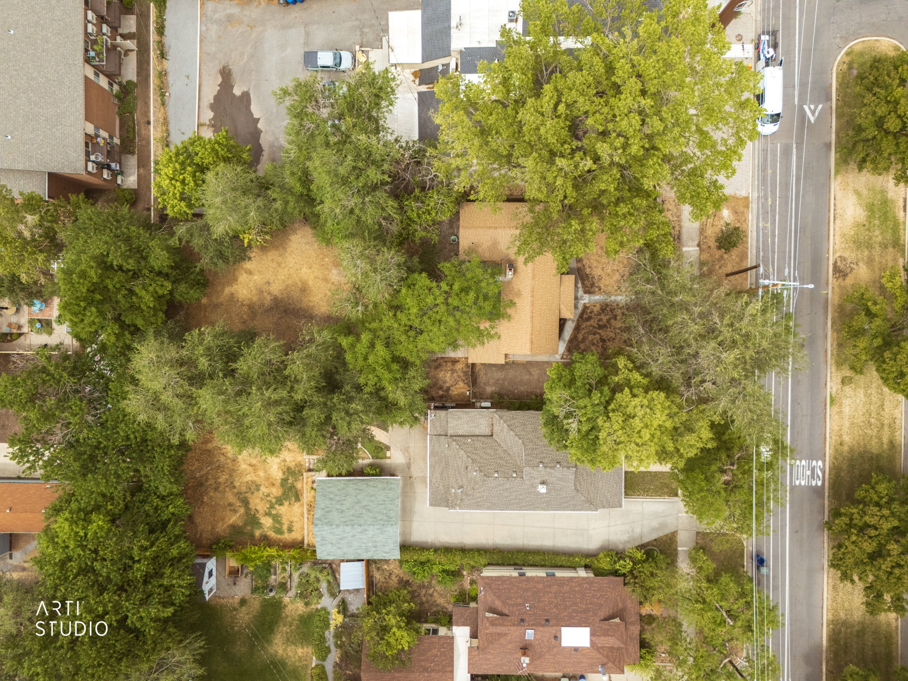 Aerial perspective showcasing a property surrounded by mature trees