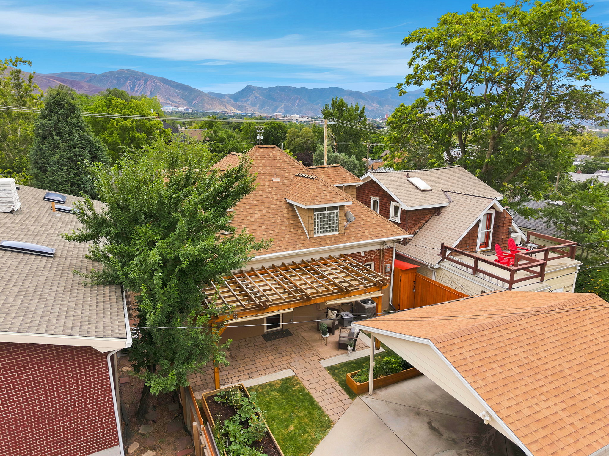 Expansive outdoor patio featuring paver flooring, a pergola, and a built-in planter box
