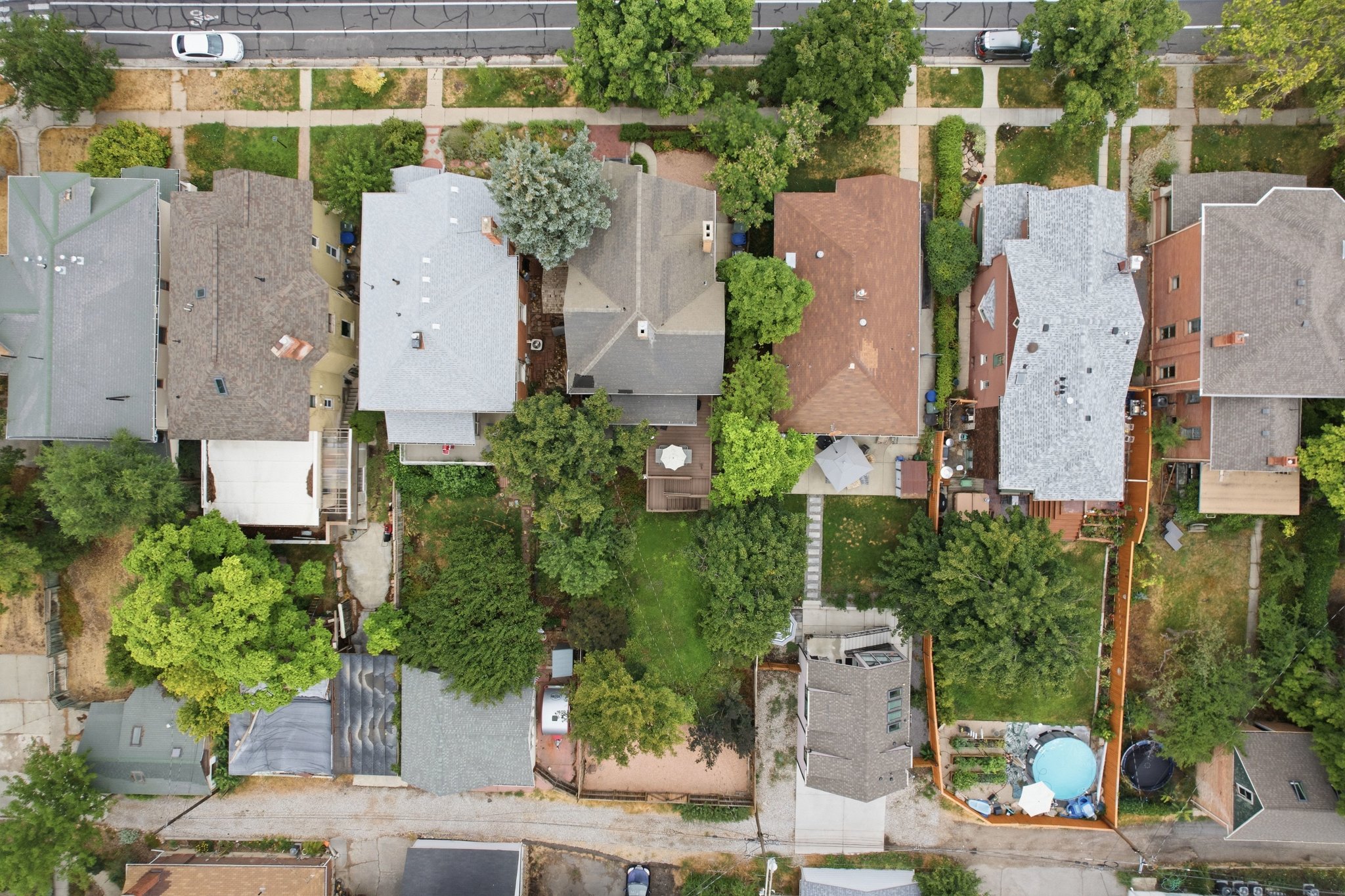 Spacious backyard featuring mature trees, a defined garden area, and wood fencing