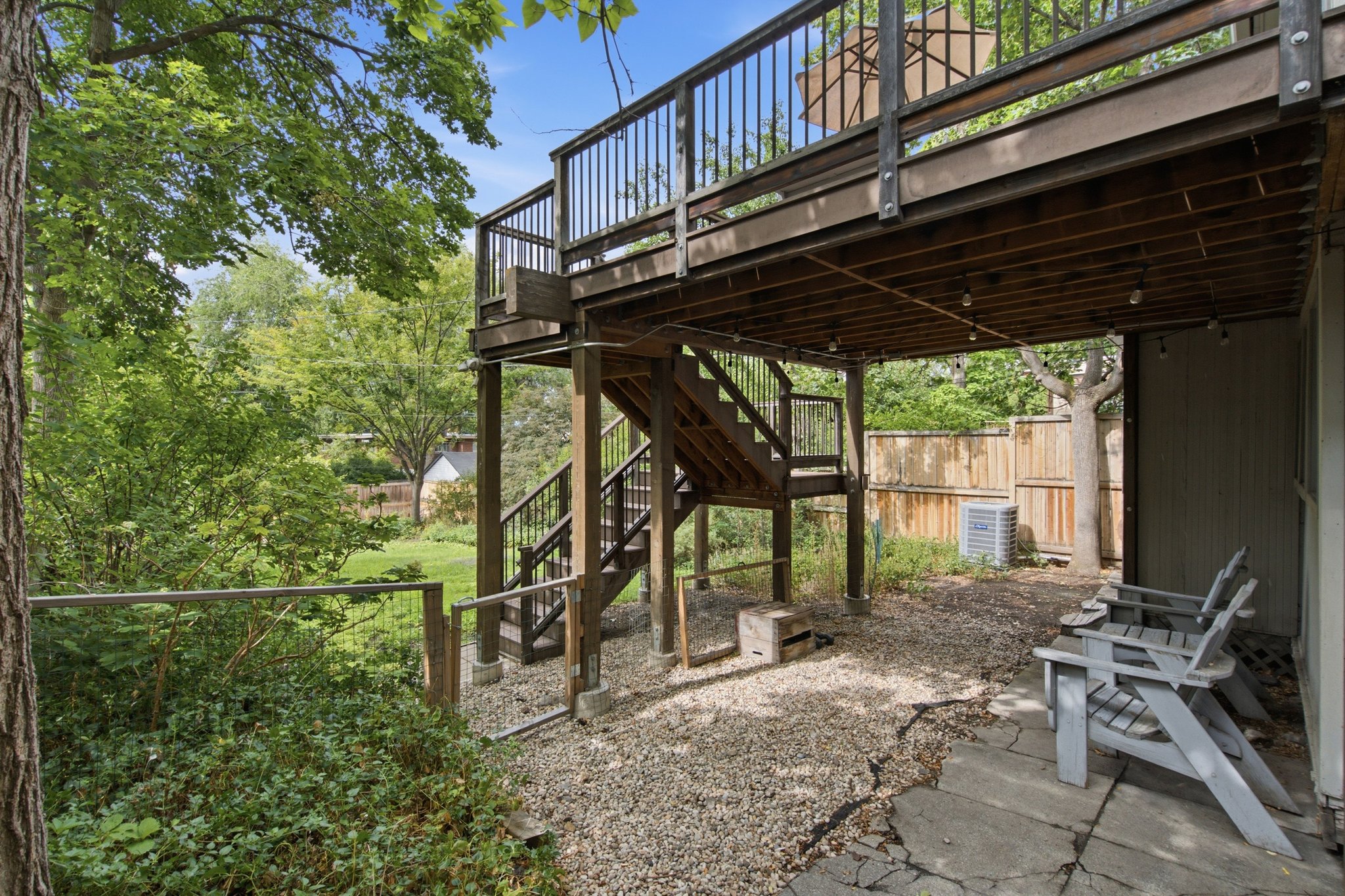 Multi-level wooden deck with baluster railing, offering exterior access to the property