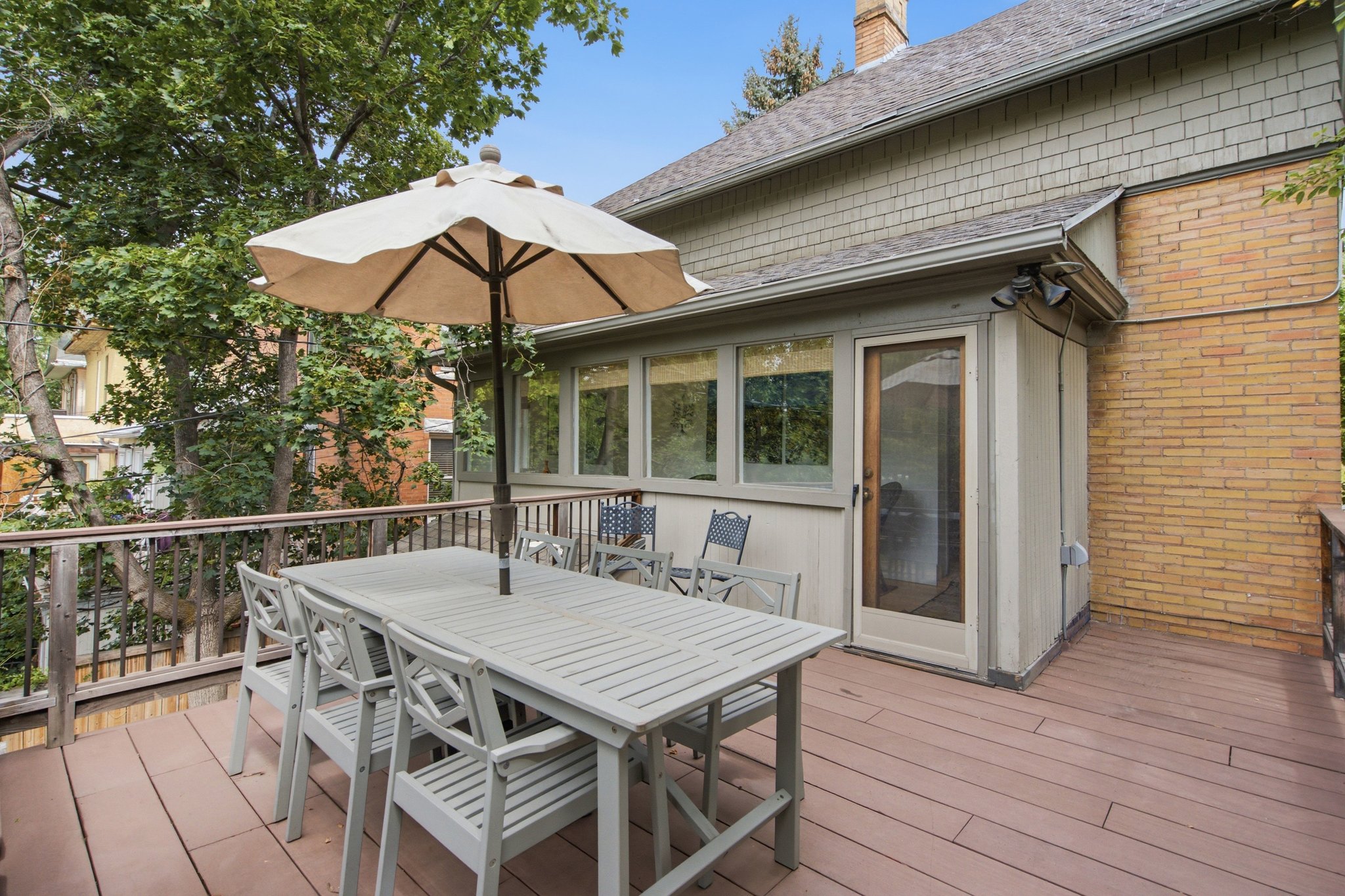 Spacious outdoor deck featuring brown composite decking and wood railings